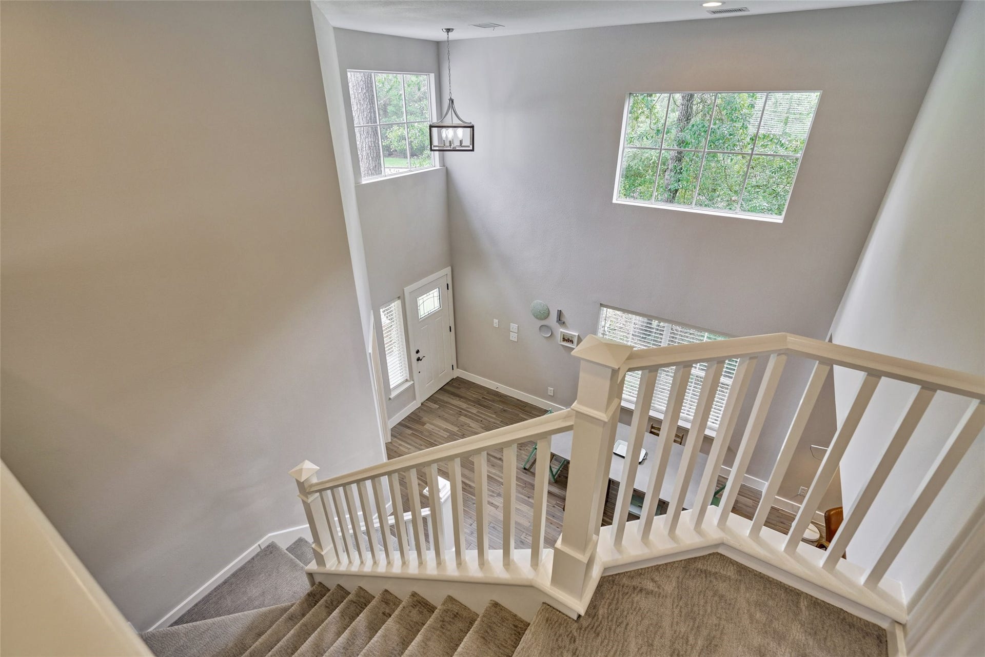 38 E Gaslight Place, The Woodlands, TX 77382 The view from the second floor looking down toward the dining area and entryway. Fresh and inviting this home is ready for move in!