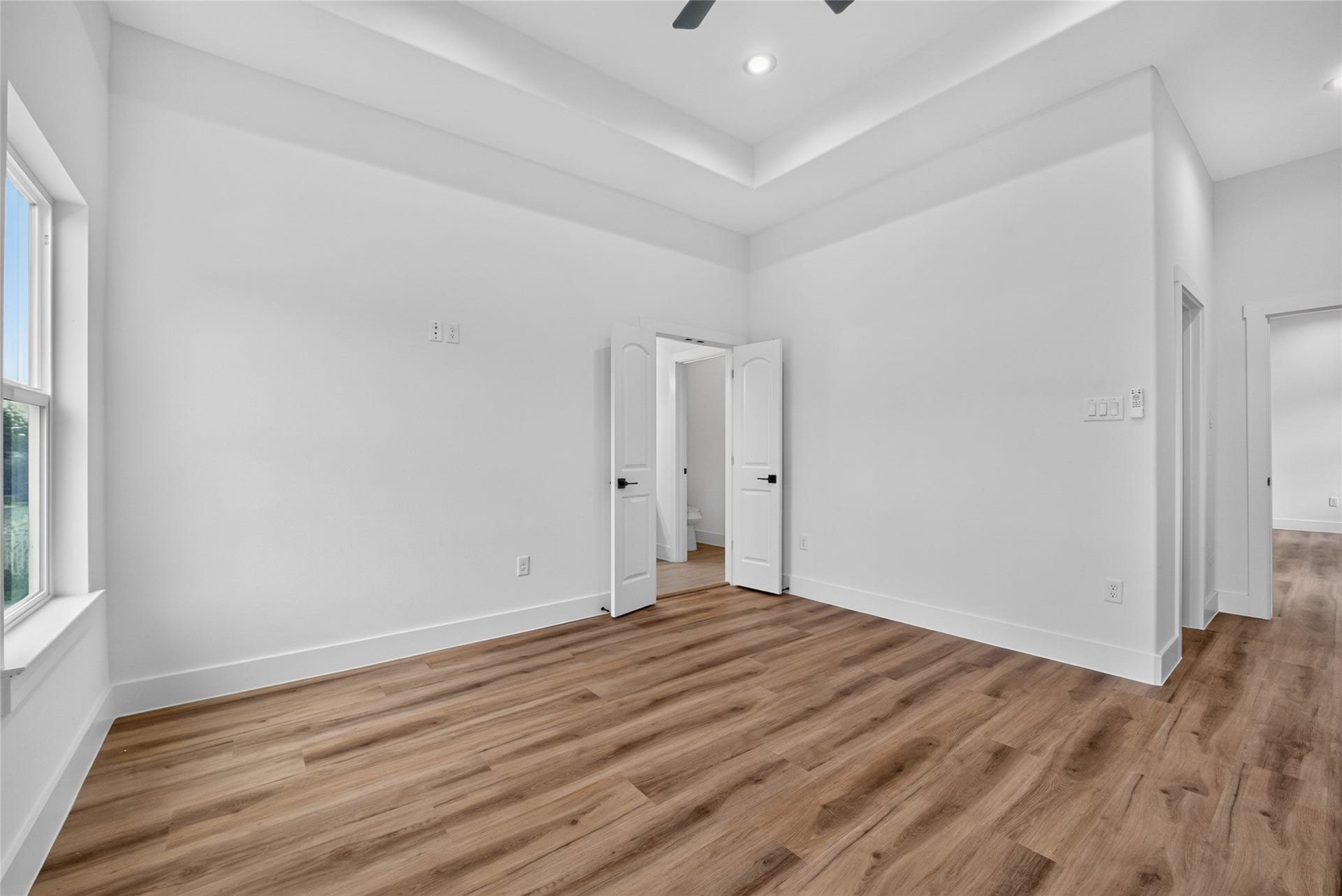 The spacious primary bedroom with a private ensuite bath is thoughtfully positioned for privacy with direct access from the versatile flex space.