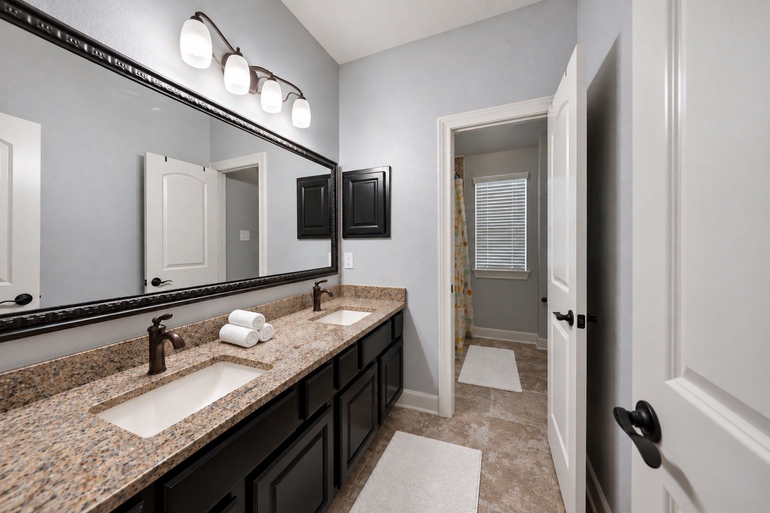 10 Camplight Court, Spring, TX 77389 Double sinks with a separate shower/tub combo and water closet.