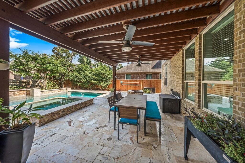 10 Camplight Court, Spring, TX 77389 Extensive decking and a covered patio.
