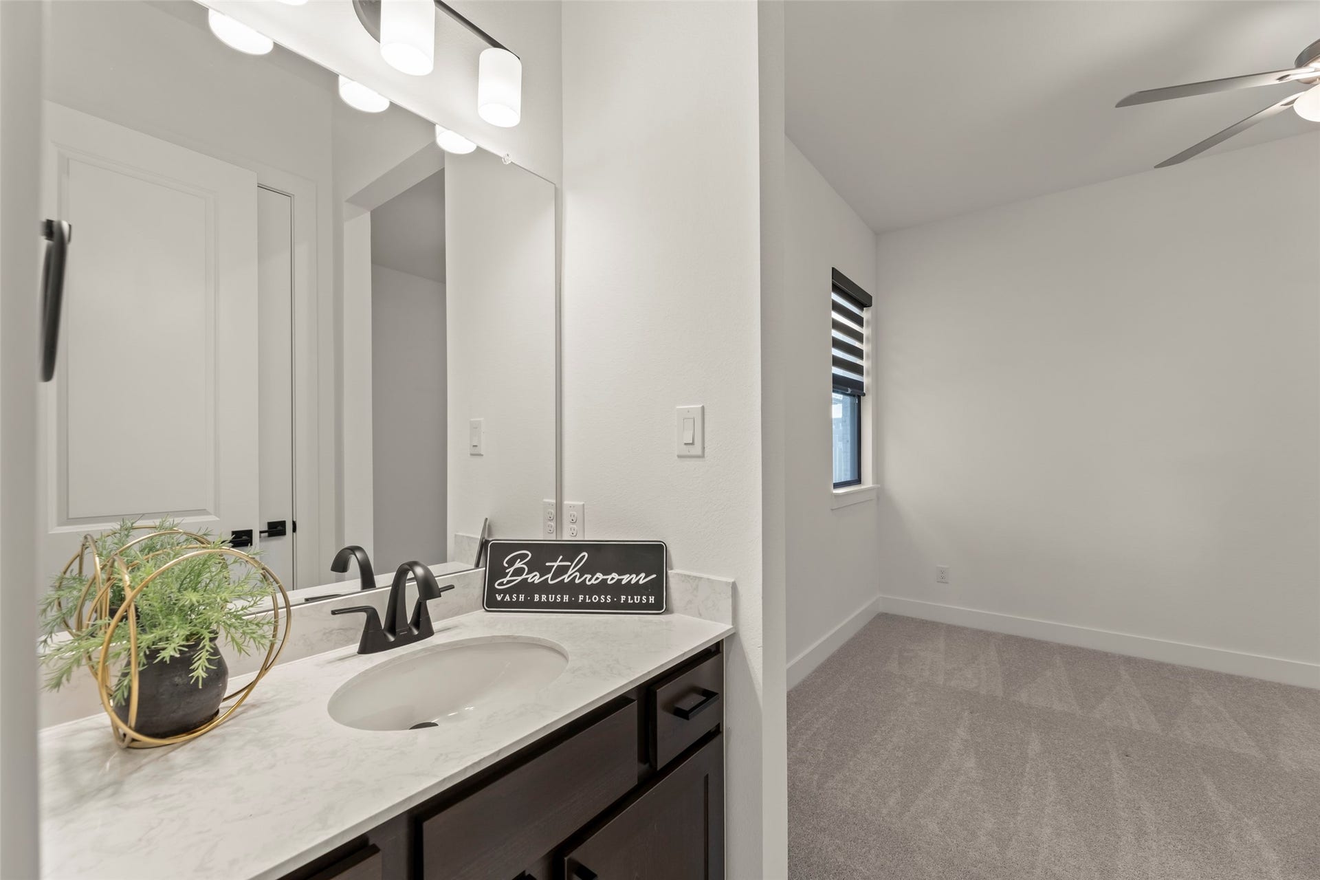 2015 Jade Manor Drive, Rosenberg, TX 77469 Cozy, carpeted bedroom featuring a stylish ceiling fan and ample natural light.