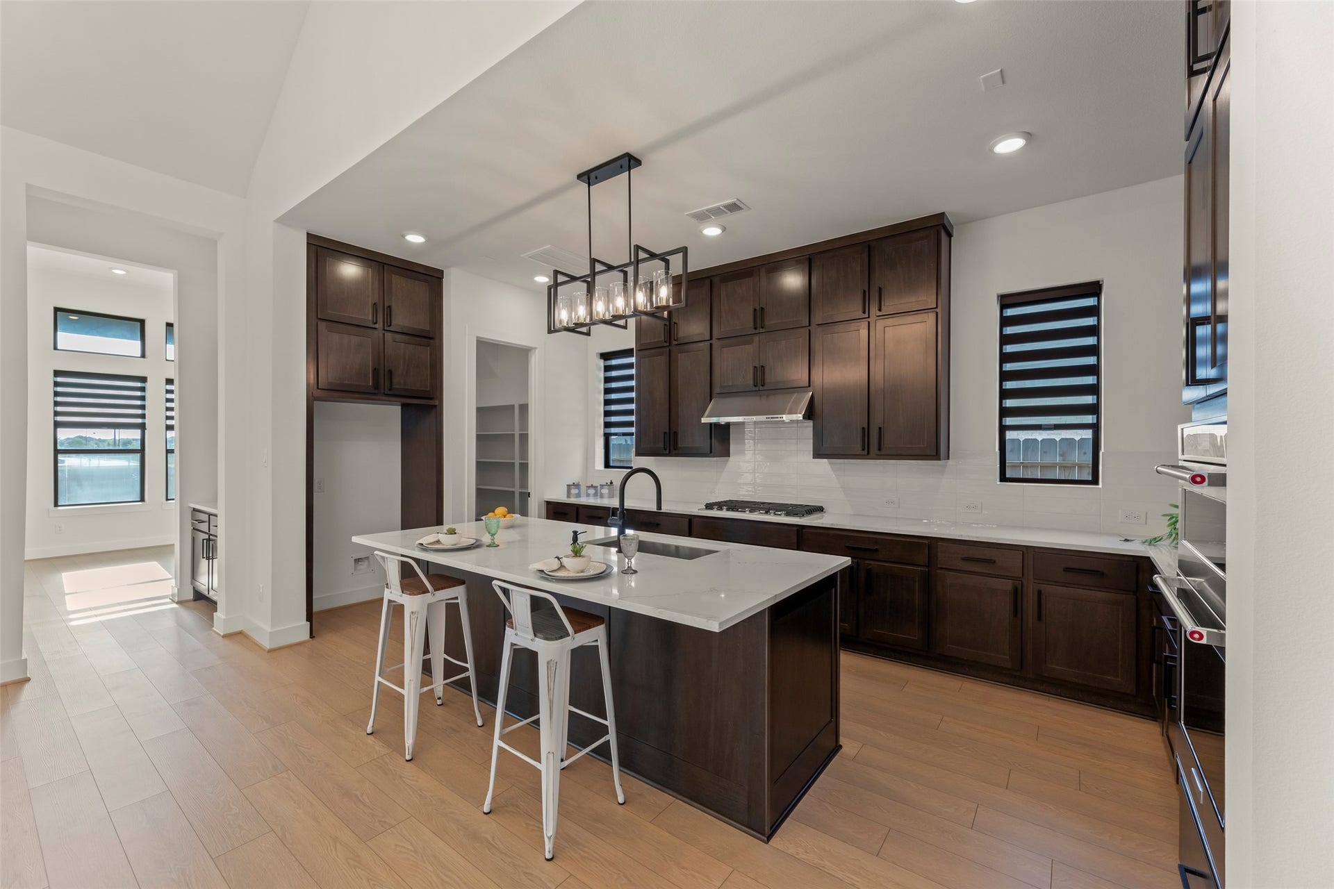 2015 Jade Manor Drive, Rosenberg, TX 77469 Elegant kitchen featuring dark wood cabinetry.