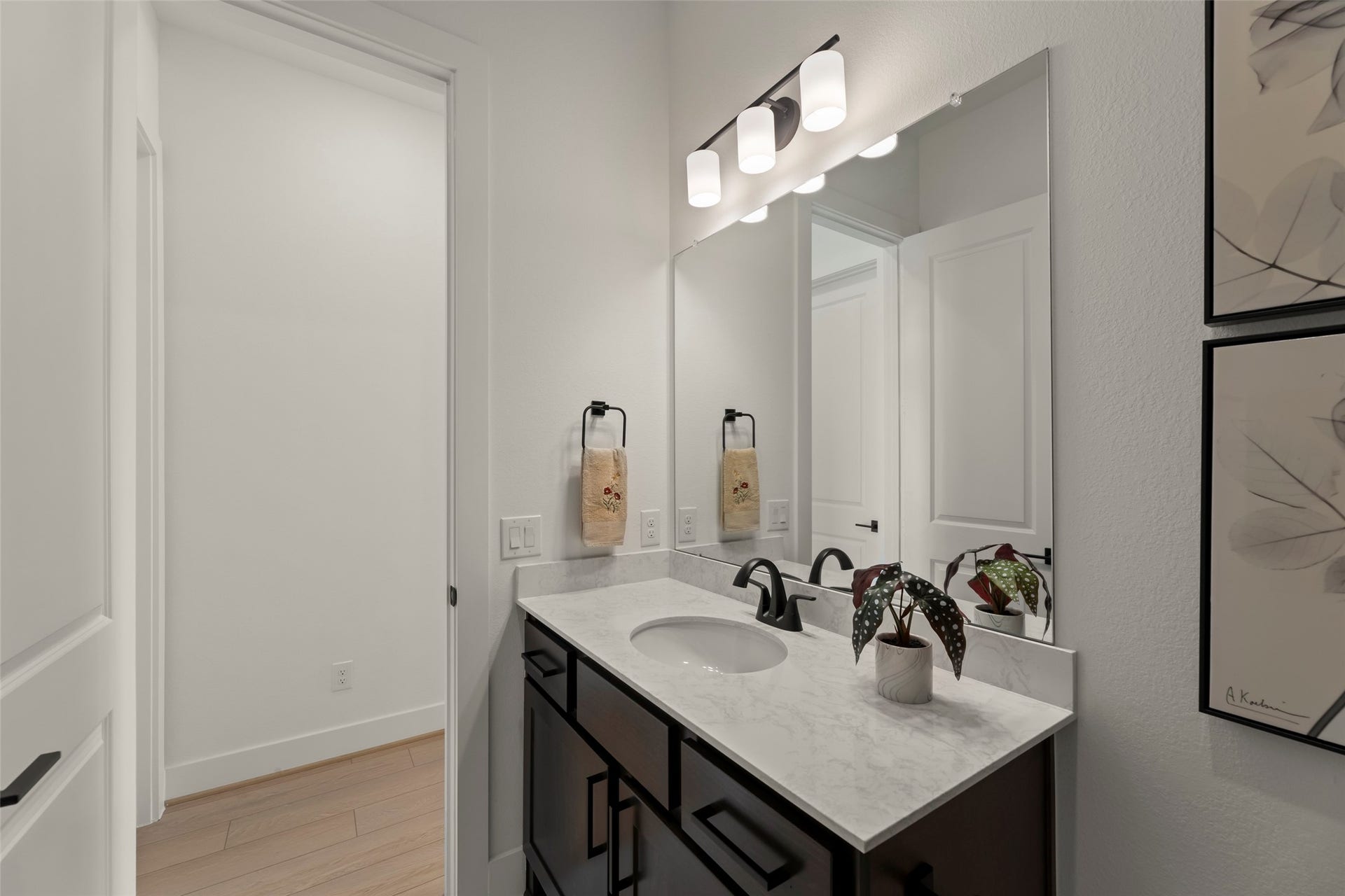 2015 Jade Manor Drive, Rosenberg, TX 77469 Modern bathroom with a sleek marble countertop, stylish black fixtures, and ample lighting.