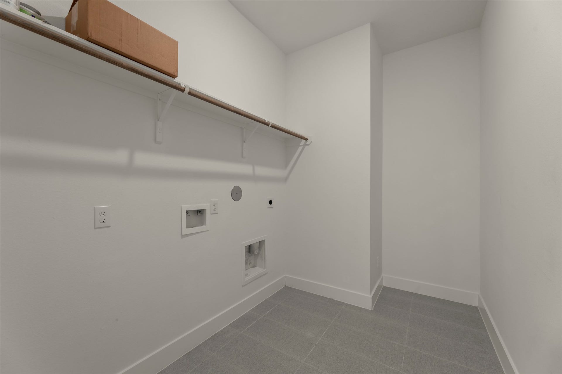 2015 Jade Manor Drive, Rosenberg, TX 77469 Laundry room with tile flooring, ample shelving, and washer/dryer hookups, perfect for organization and convenience.
