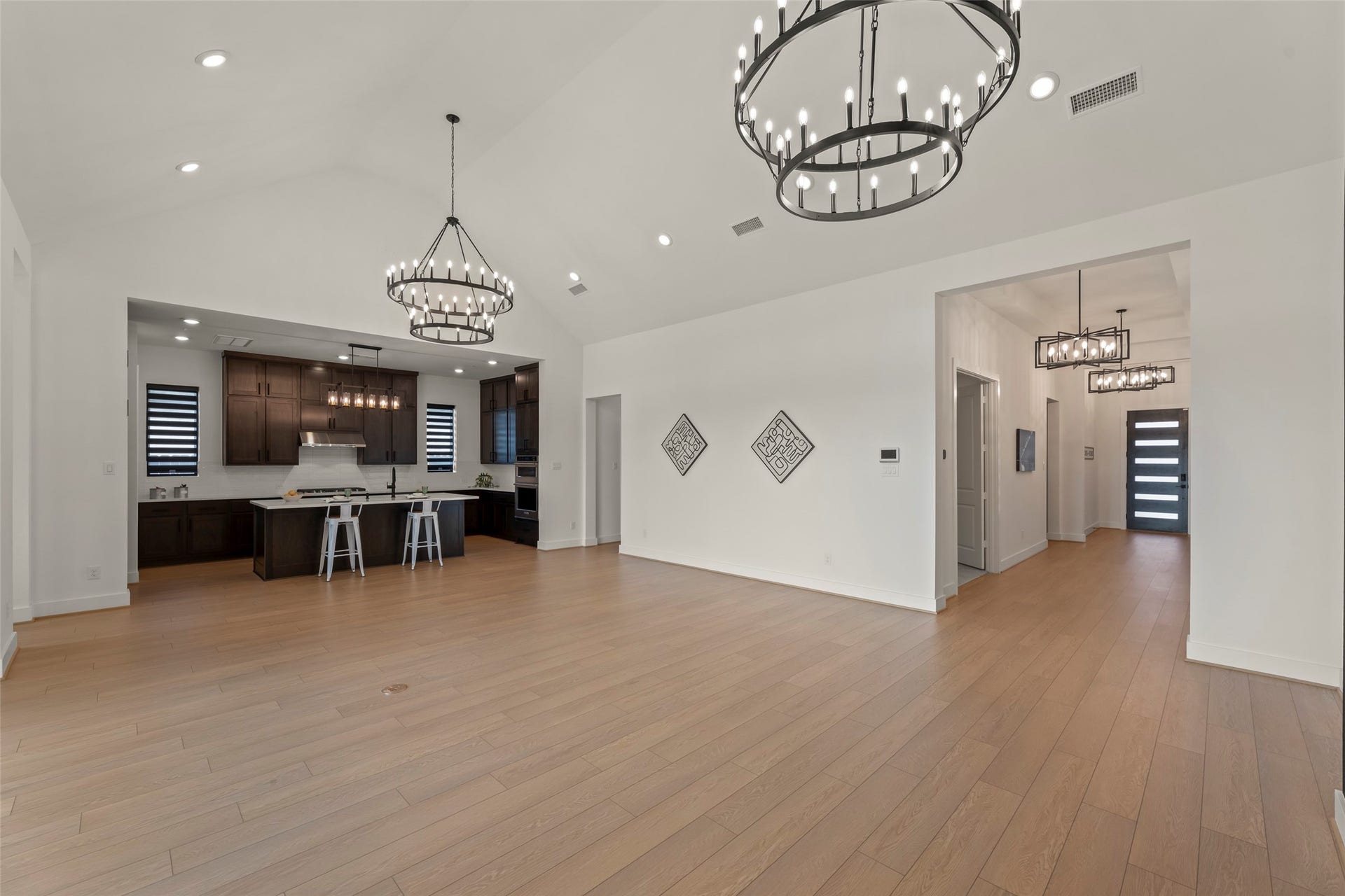 2015 Jade Manor Drive, Rosenberg, TX 77469 Spacious open-concept family room area featuring elegant chandeliers.