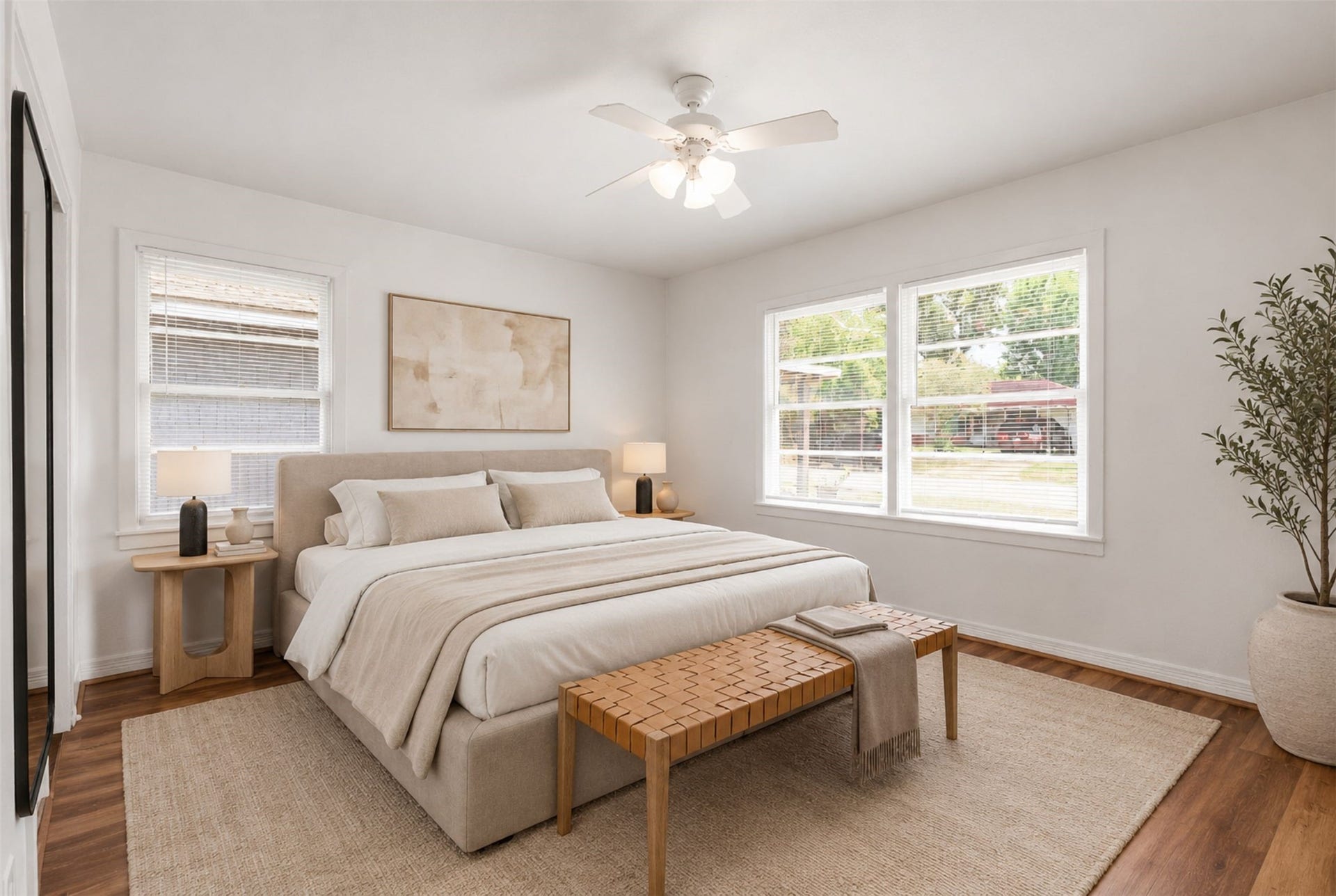 6630 Maybank Drive, Houston, TX 77055 Experience serene comfort in this bedroom, featuring abundant natural light, warm wood flooring, and elegant furnishings that create a peaceful retreat. (Virtual Staging)