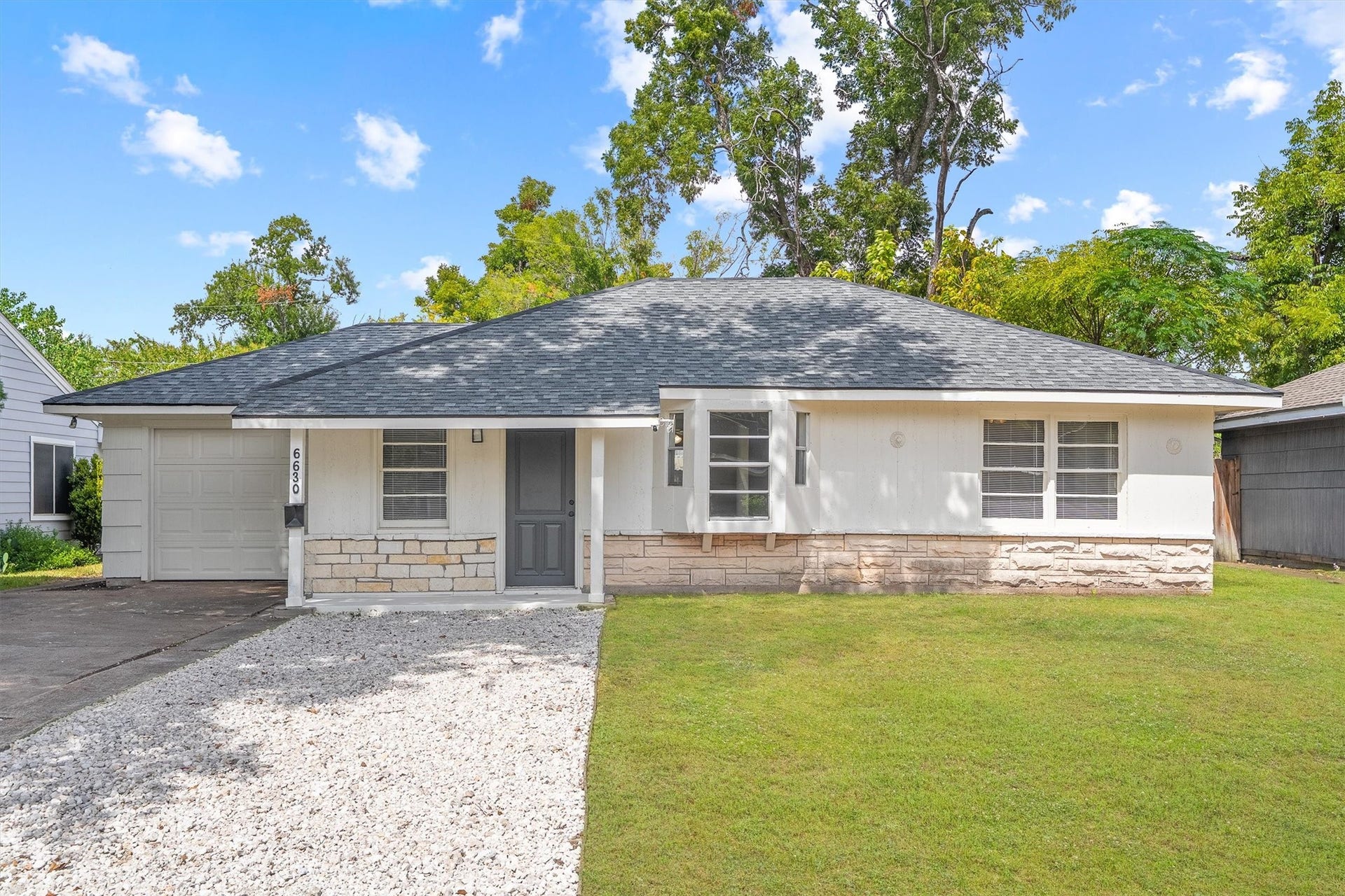 6630 Maybank Drive, Houston, TX 77055 Attractive single-story home with a fresh, modern exterior, featuring a well-maintained lawn, a sleek gray roof, and an attached garage.