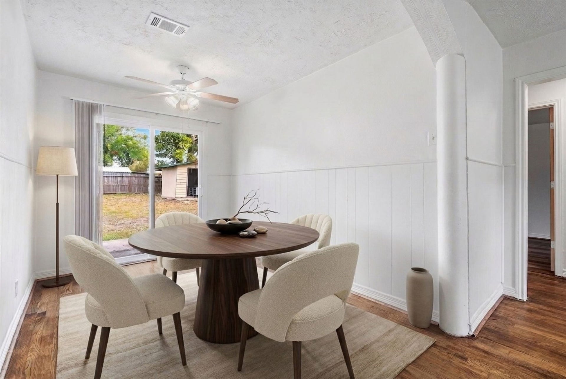 6630 Maybank Drive, Houston, TX 77055 Experience the perfect blend of style and comfort in this dining area, featuring a serene view of the backyard through sliding glass doors. (Virtual Staging)
