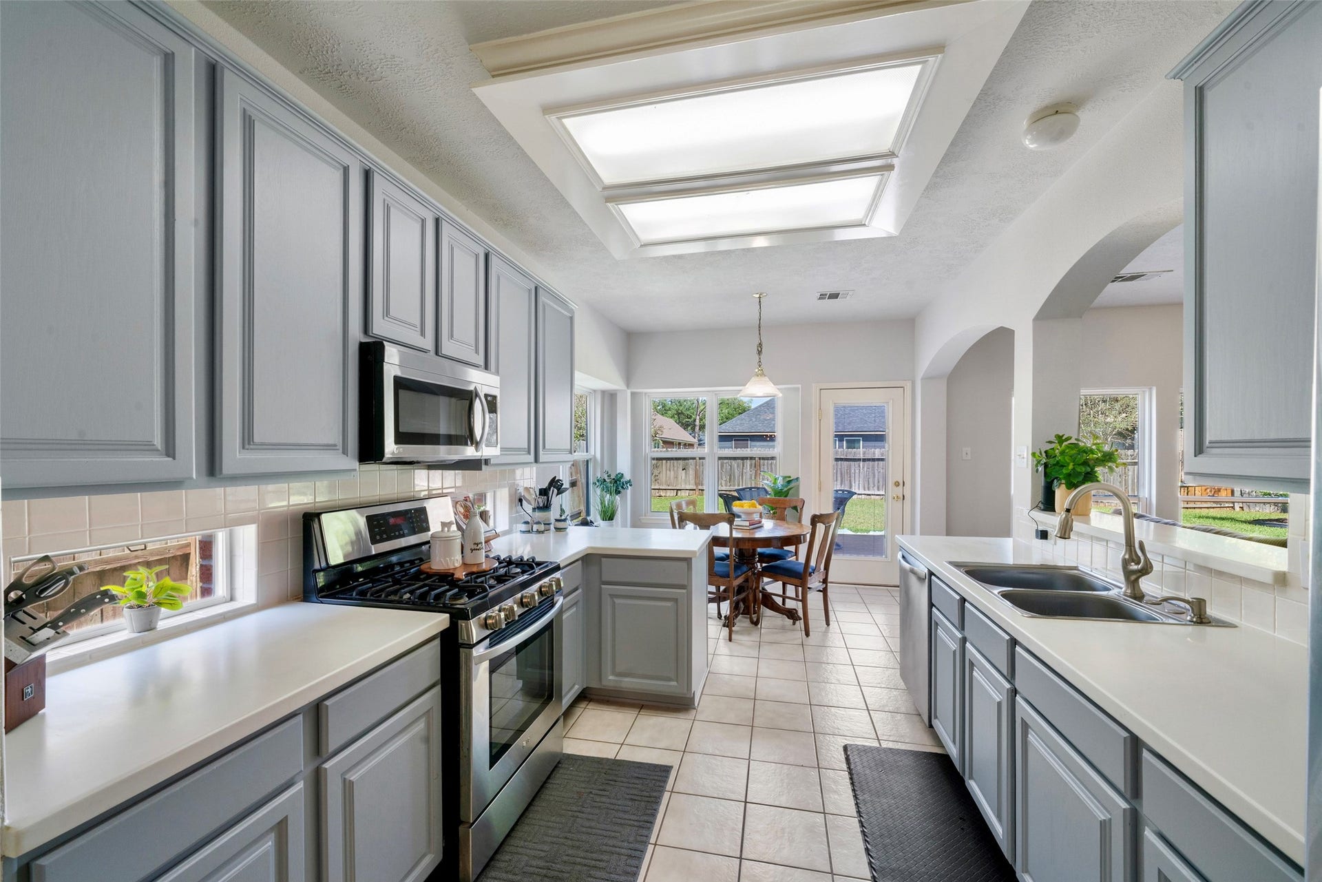 3607 Parkshire Drive, Pearland, TX 77584 Bright and inviting kitchen with modern, stainless appliances, ample cabinetry, and a quaint breakfast area overlooking the backyard through large, corner windows. Under-cabinet windows for extra sunshine into the space.