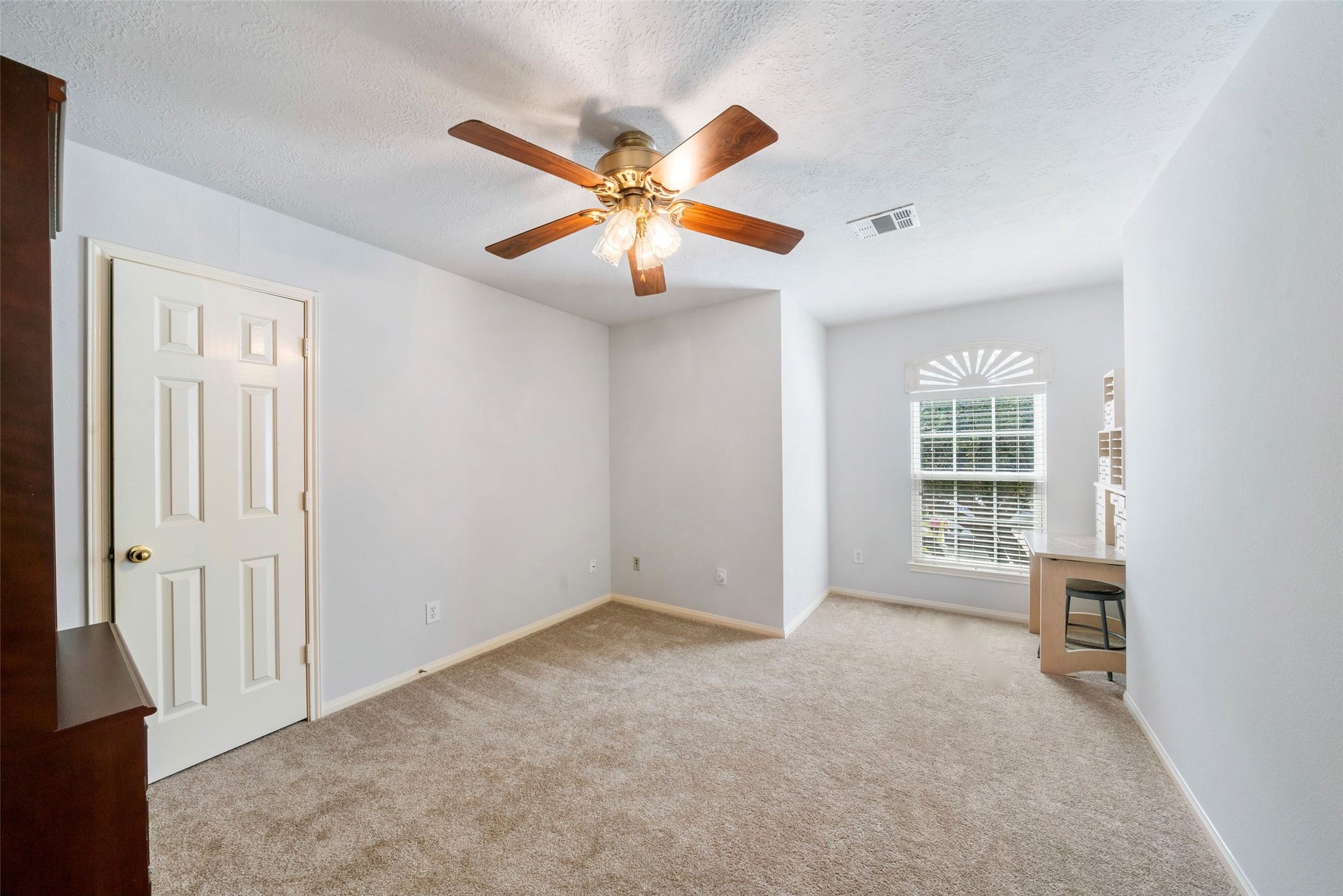 3607 Parkshire Drive, Pearland, TX 77584 Bright and spacious room featuring a ceiling fan, plush carpeting, and a large window with elegant shutters, a perfect retreat or home office.