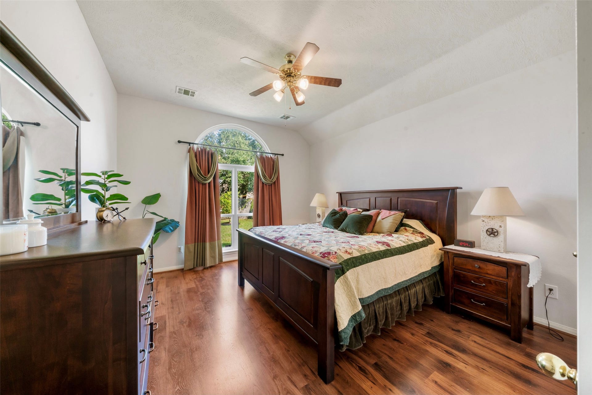 3607 Parkshire Drive, Pearland, TX 77584 Spacious bedroom with elegant flooring, featuring a large window with backyard views, a ceiling fan, and high ceiling, making a wonderful retreat.