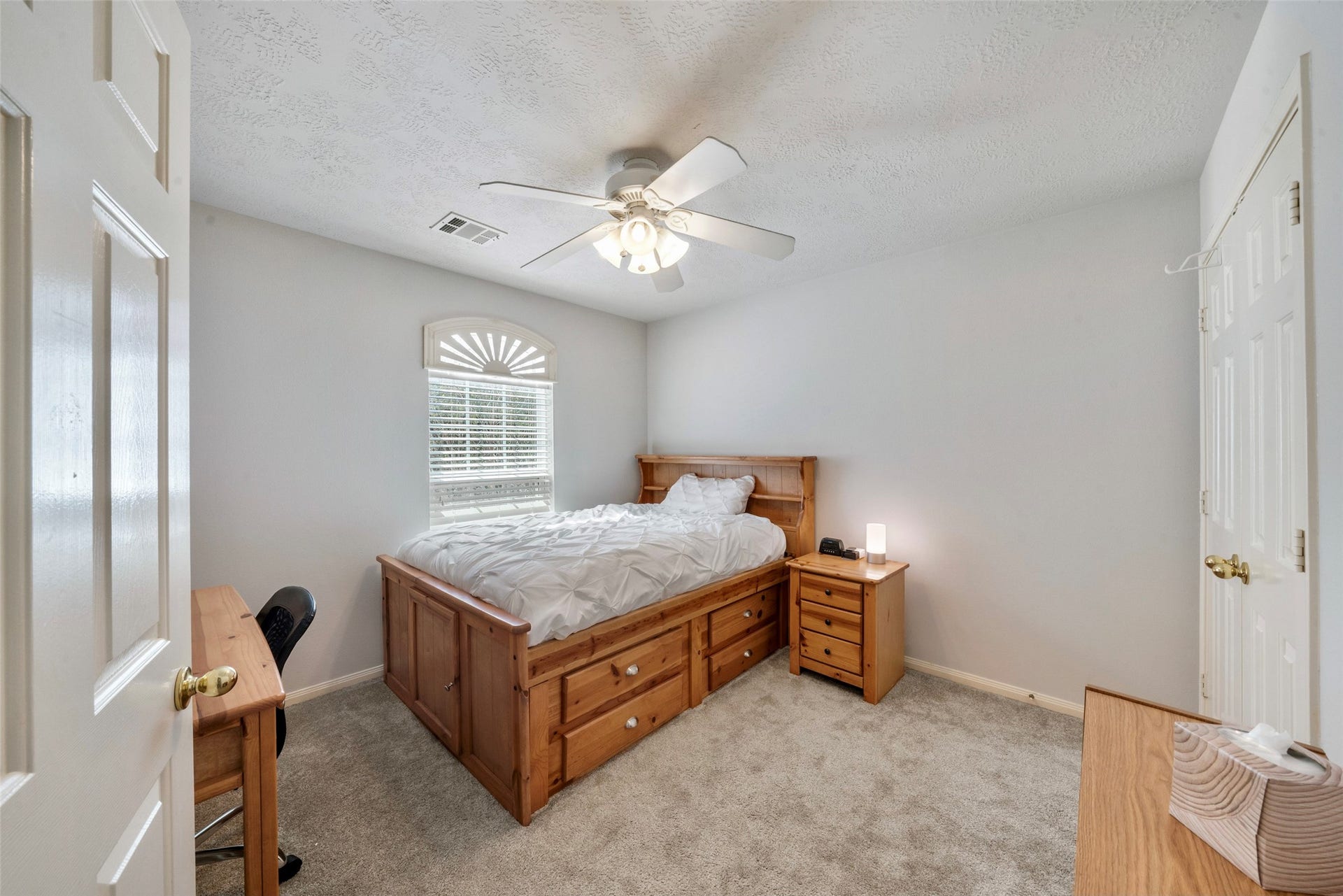 3607 Parkshire Drive, Pearland, TX 77584 Guest bedroom 2 featuring soft carpet, and a ceiling fan, illuminated by natural light from a window with charming shutters and a double-closet.