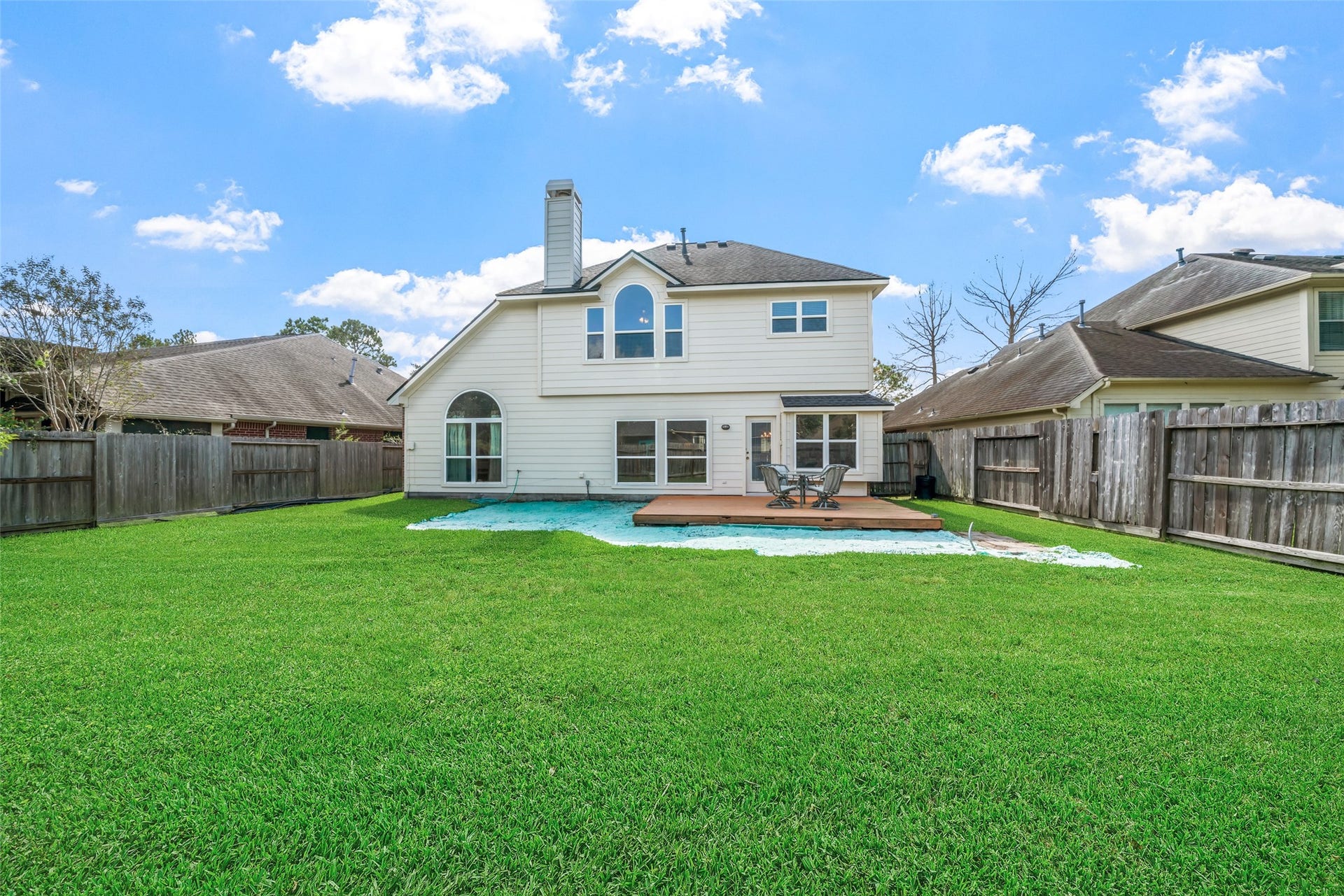 3607 Parkshire Drive, Pearland, TX 77584 Spacious back yard with wooden deck for entertaining. Some decking was removed, so grass treatment was installed to facilitate new grass growth.