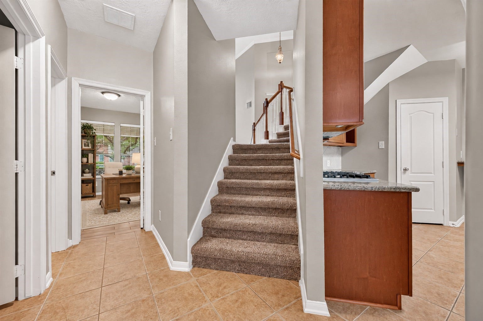 A convenient back stairway connects directly to the dining and kitchen area, providing easy access to the second floor. Just off the hall are the laundry room and a full secondary bathroom, with the first-floor bedroomcurrently used as a home officelocated just beyond. **Virtually Staged**