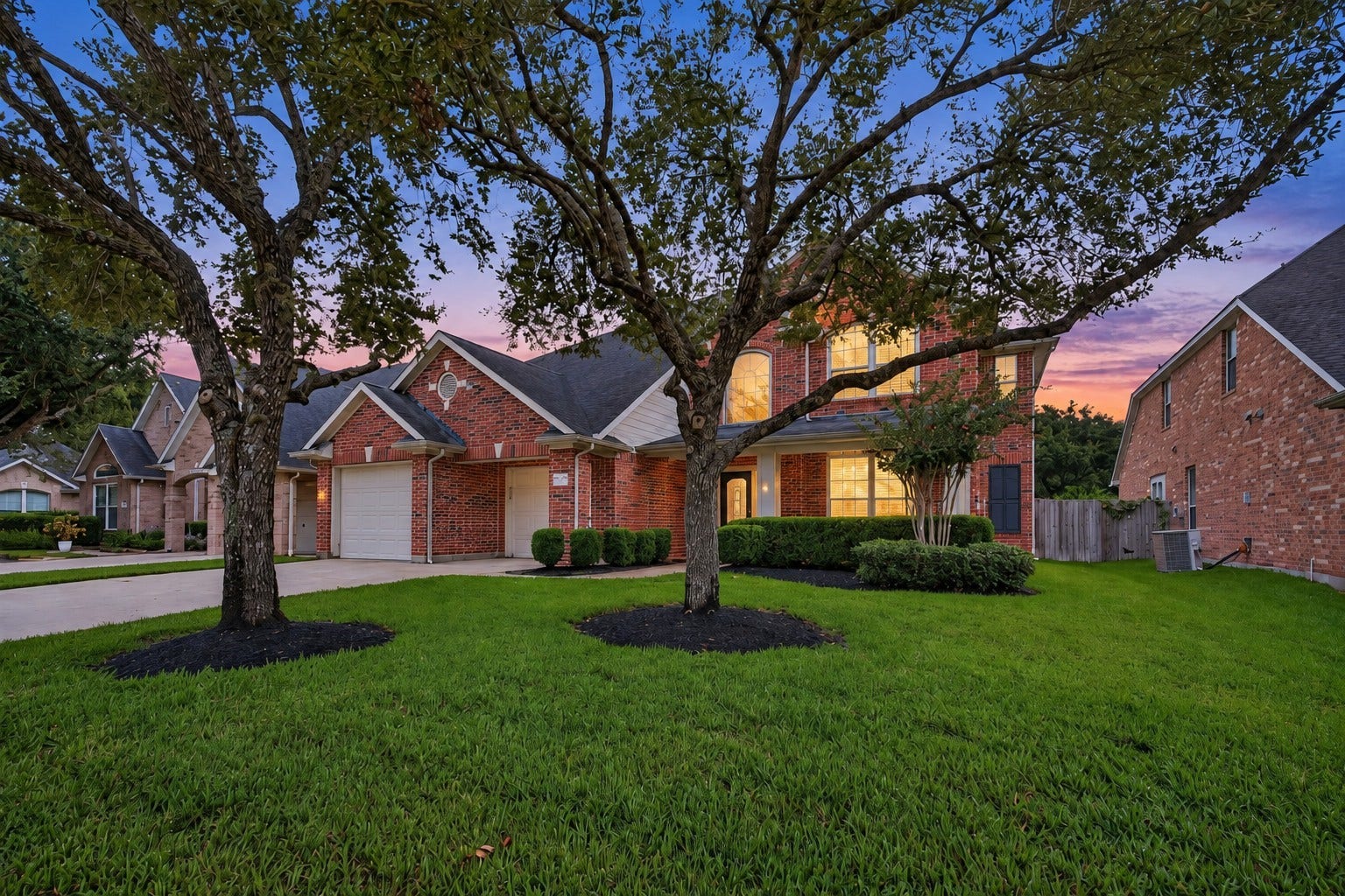 The mature, well-maintained landscaping enhances the homes curb appeal and creates a welcoming first impression. The established greenery beautifully complements the brick exterior for a polished, inviting look.