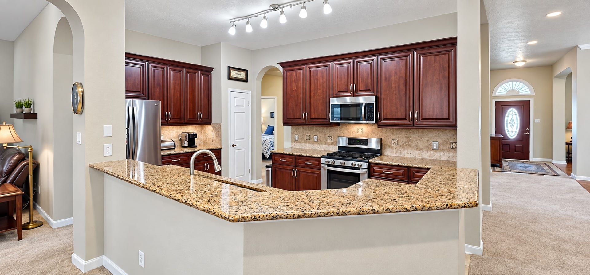 3511 Harbor Pass Lane, Friendswood, TX 77546 Experience culinary delight in this spacious kitchen, featuring ample granite countertops and rich wood cabinetry for all your storage needs.