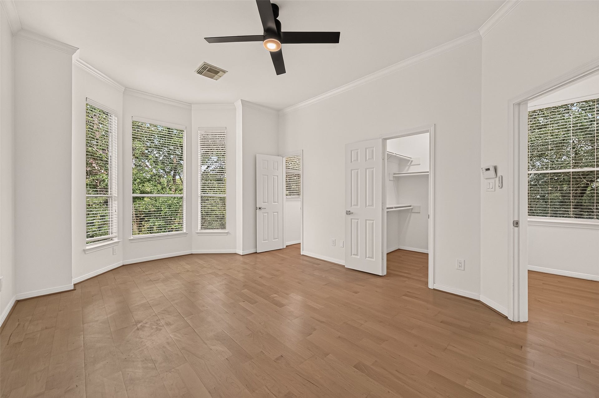 2903 Austin Street, Houston, TX 77004 Master bedroom with 2 walk-in closets. The door on the left is a large walk-in closet with a window.