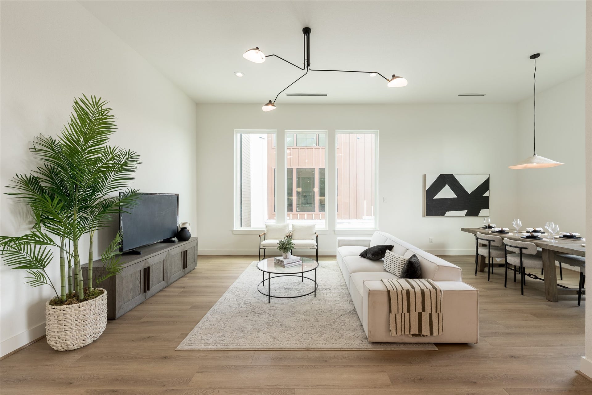 2009 Gregg Street, Houston, TX 77026 Living room with large windows, and elegant lighting fixture, perfect for both relaxation and entertaining.