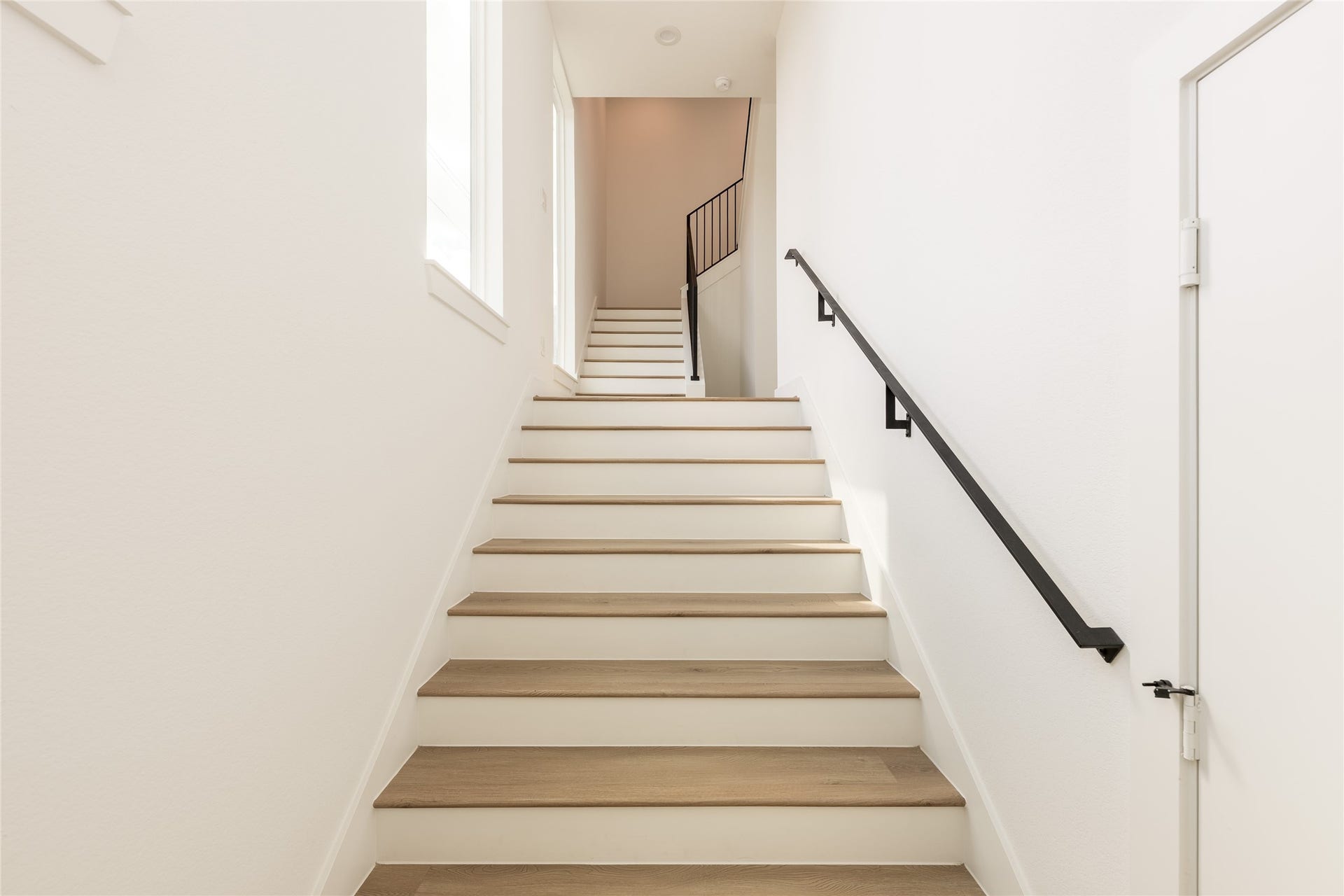 2009 Gregg Street, Houston, TX 77026 Inviting staircase with sleek handrails and wide modern wood steps, leading to the upper level filled with natural light.