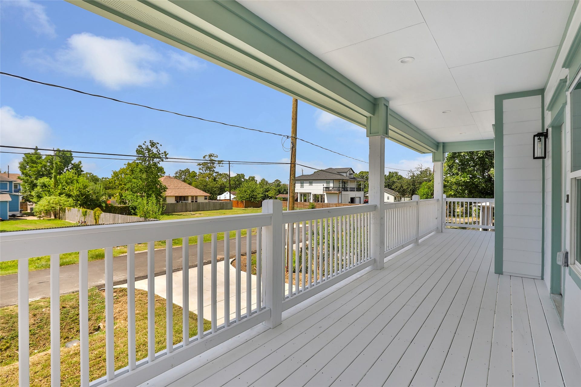 Spacious covered porch offers a relaxing outdoor space with charming neighborhood views.