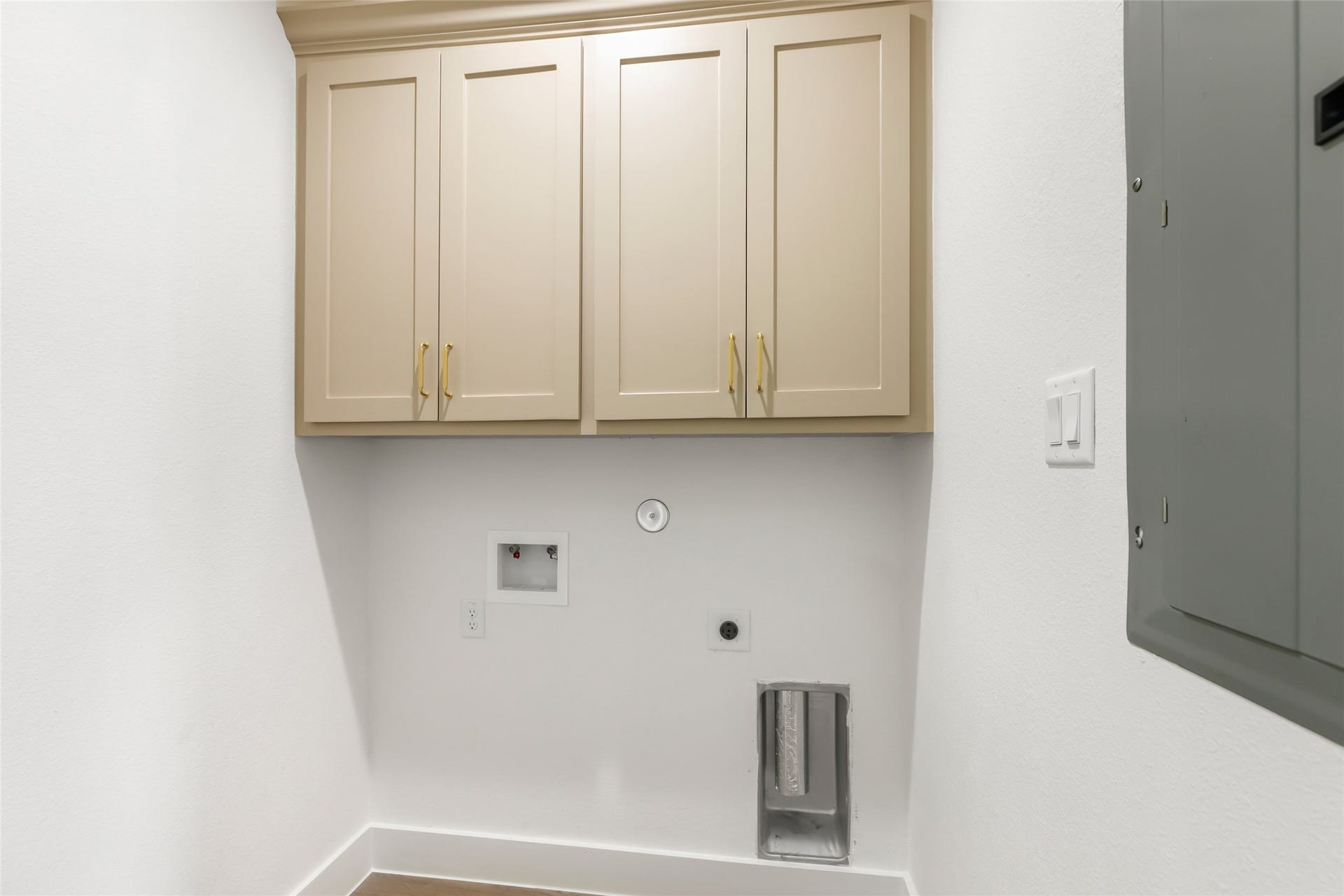 Laundry room has cabinetry storage.