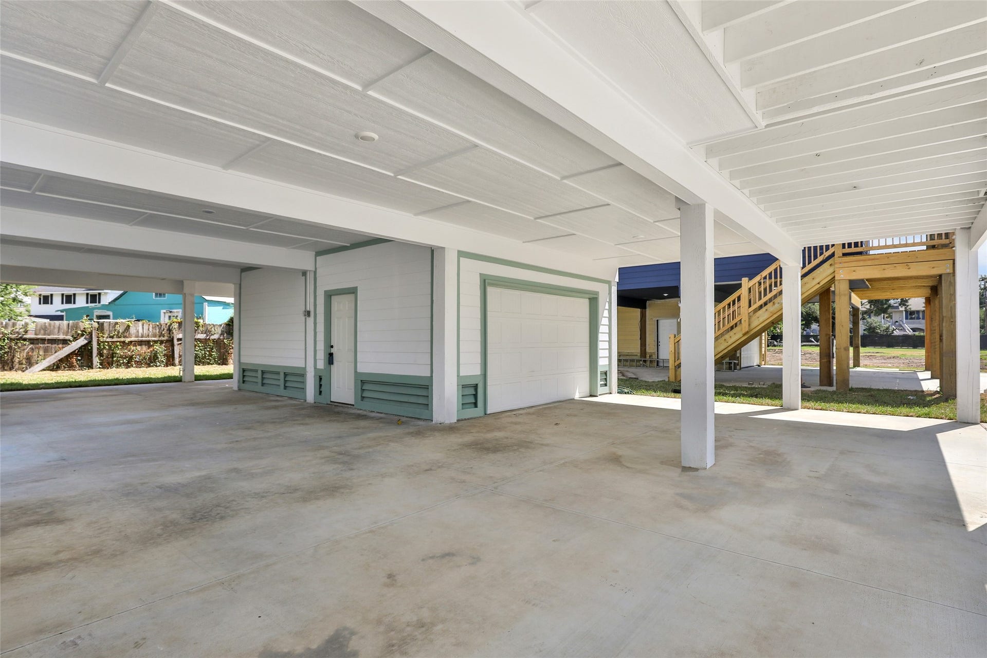 Spacious covered parking area and storage area.