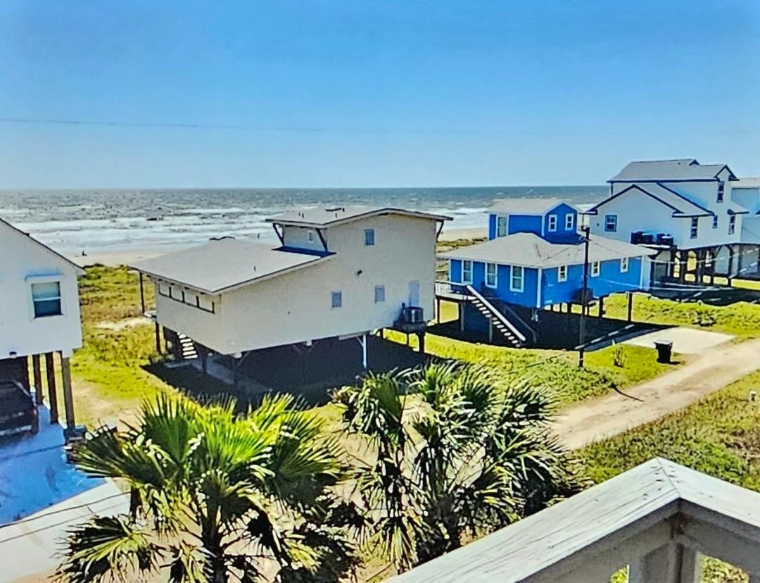 21519 San Luis Pass Road, Galveston, TX 77554 Beach view with a clear blue sky, showcasing proximity to the ocean. Ideal for coastal enjoyment.