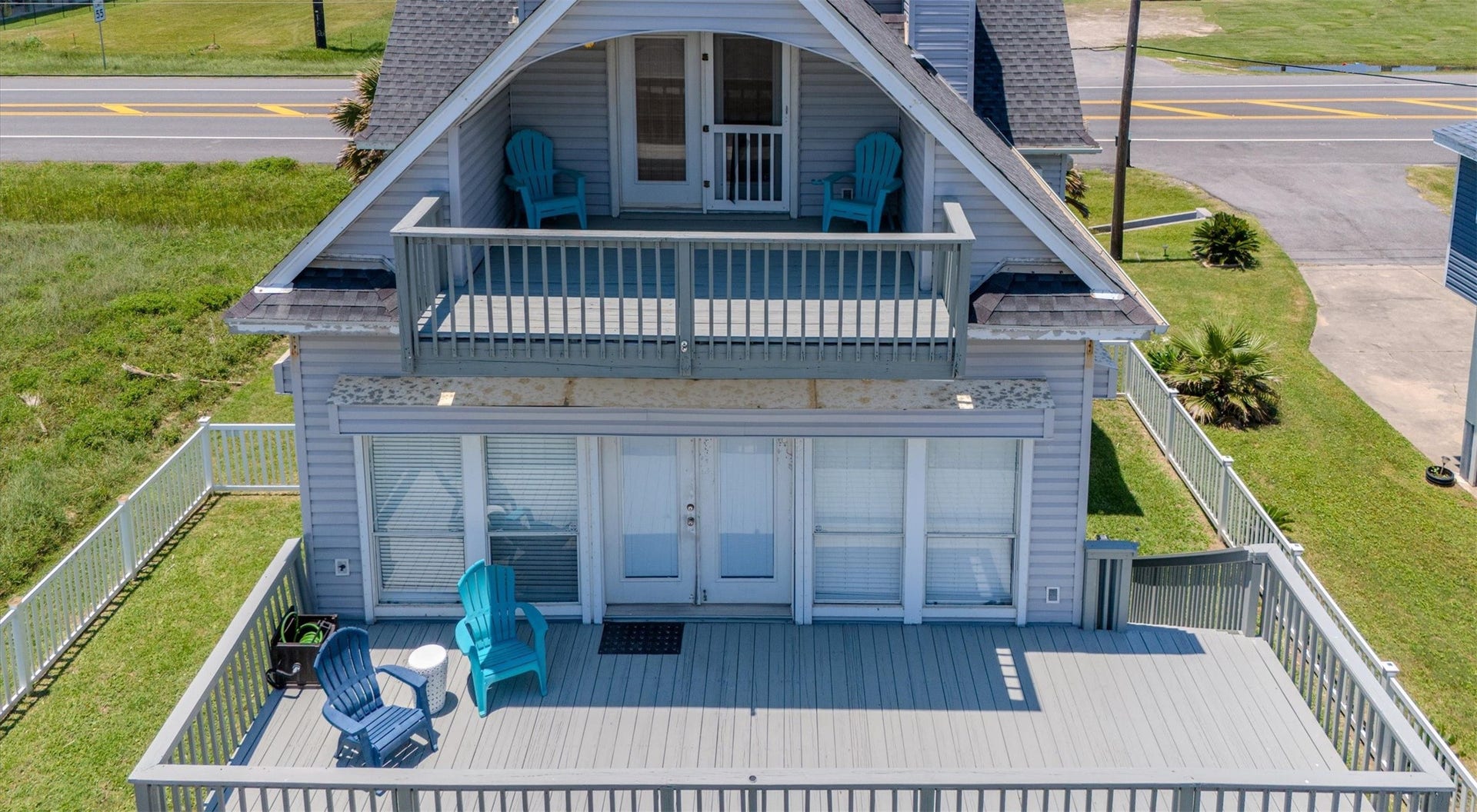21519 San Luis Pass Road, Galveston, TX 77554 This charming home has spacious dual-level decks, perfect for outdoor relaxation. The upper balcony offers a cozy spot with seating, while the lower deck provides ample space for gatherings. It's set in a convenient location near the beach, with a partially fenced yard for added privacy.
