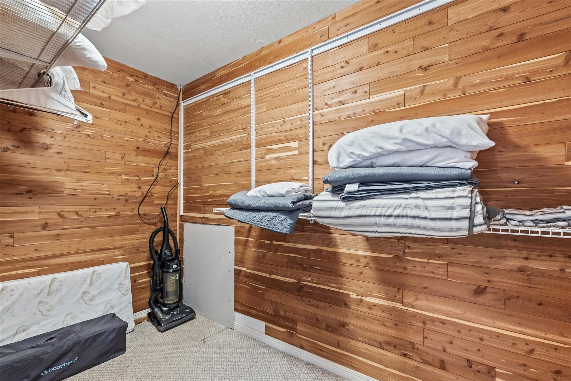 21519 San Luis Pass Road, Galveston, TX 77554 This home offers abundant storage solutions with a beautifully cedar paneled, large closet, featuring convenient shelving and a hanging rod perfect for organizing your essentials.