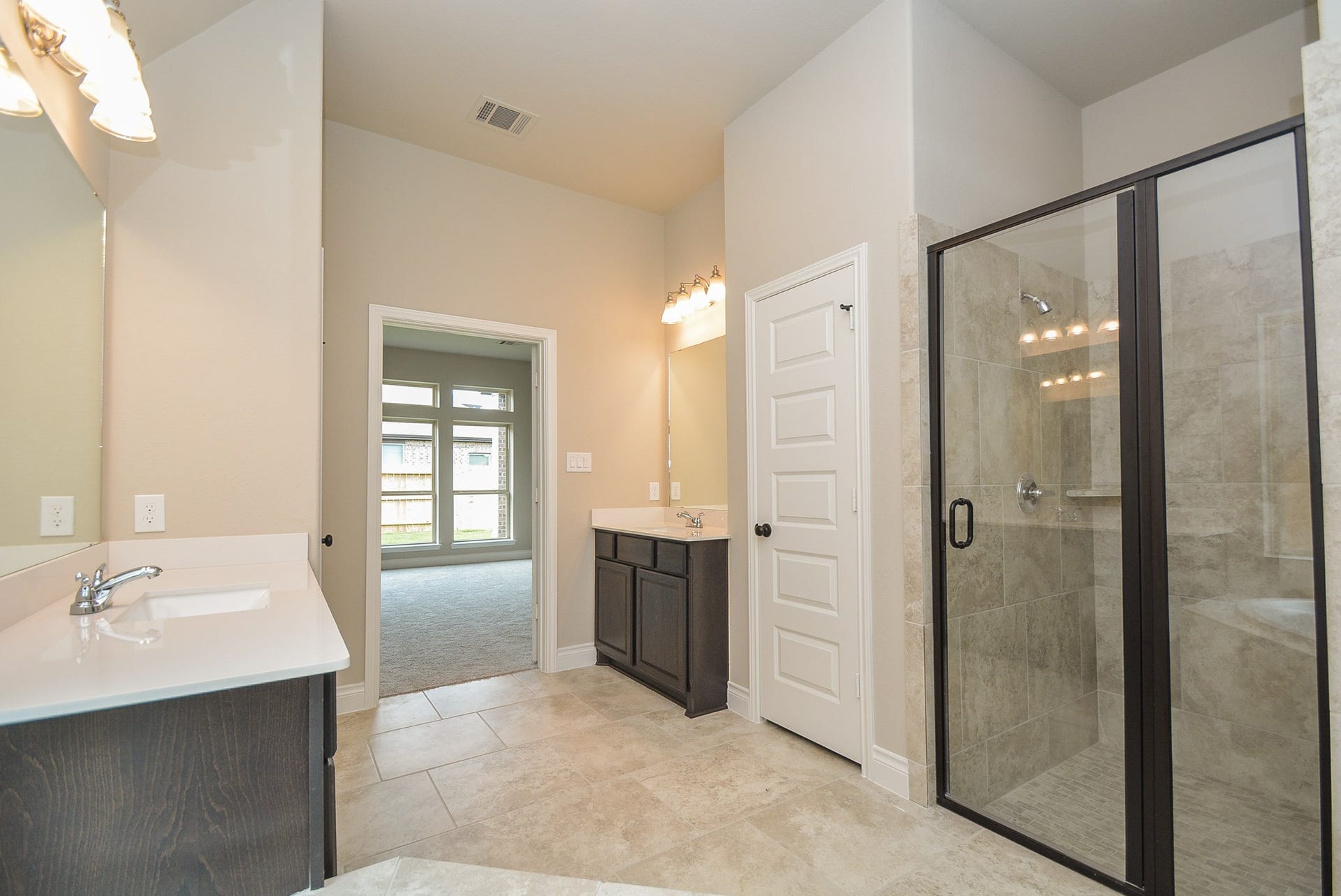 Primary master bedroom with his and hers vanities