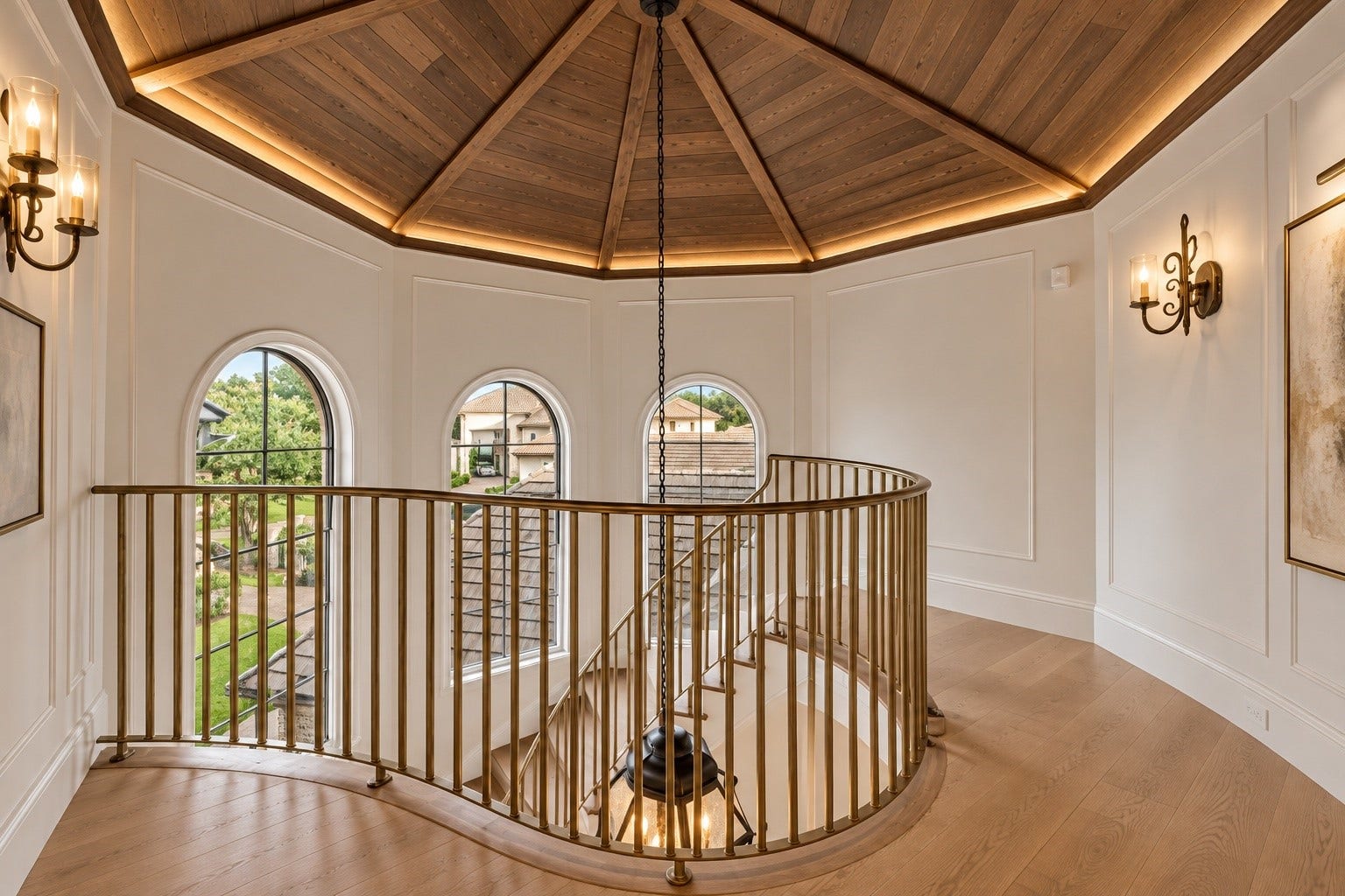 23 Beacon Hill Hill, Sugar Land, TX 77479 Beautiful ceiling geometry, architectural windows, and intricate stair railing details create an elegant upper-level landing that reflects the home's exceptional attention to design.