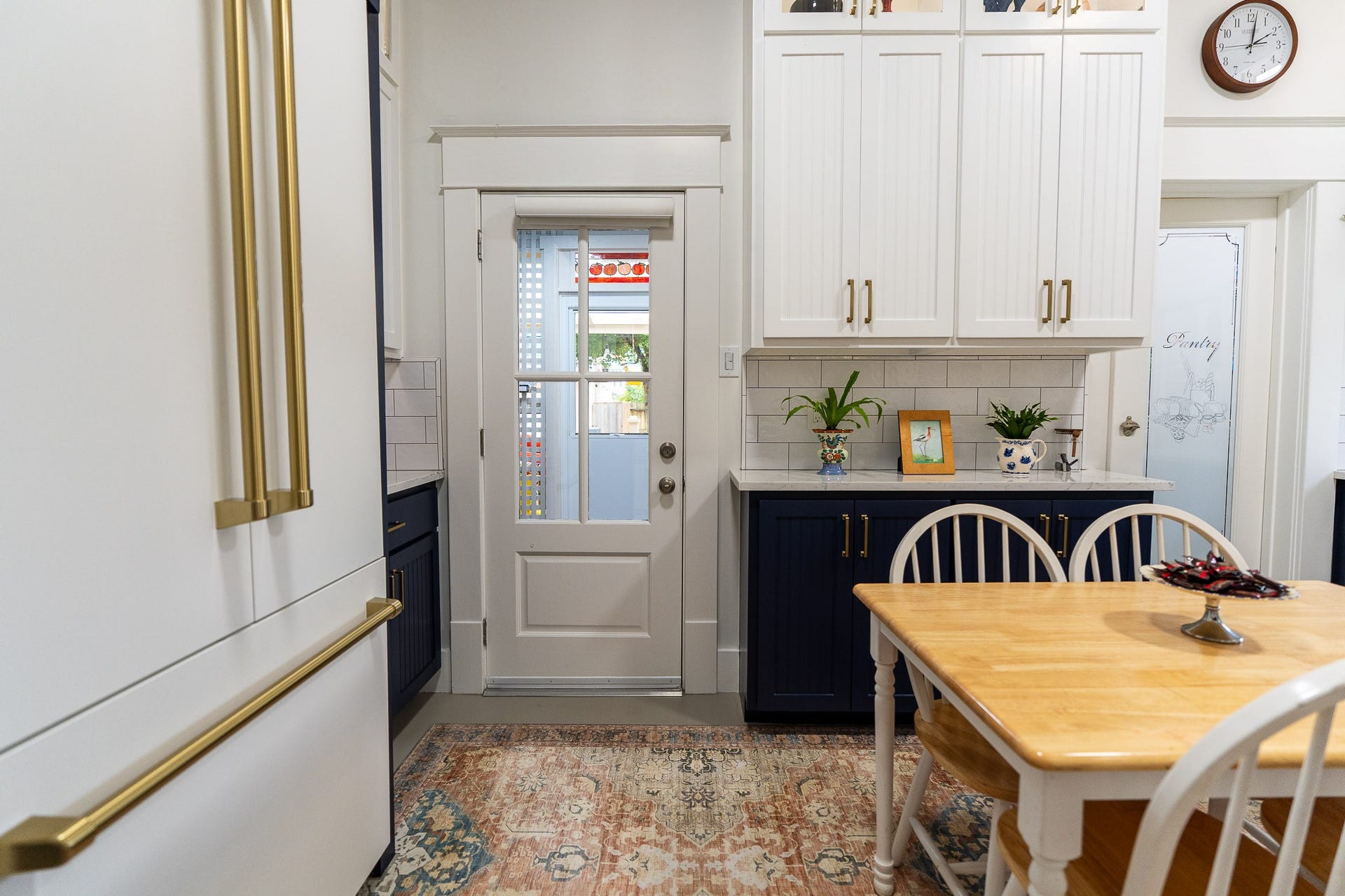 1841 Cortlandt Street, Houston, TX 77008 The glass door goes through the back porch to the back deck and double stairs. The other glass door enters the pantry with dedicated circuits for each appliance, coffee bar a window and shelving. Tall Zline cabinet depth refrigerator with water and icemaker, white with gold handles.