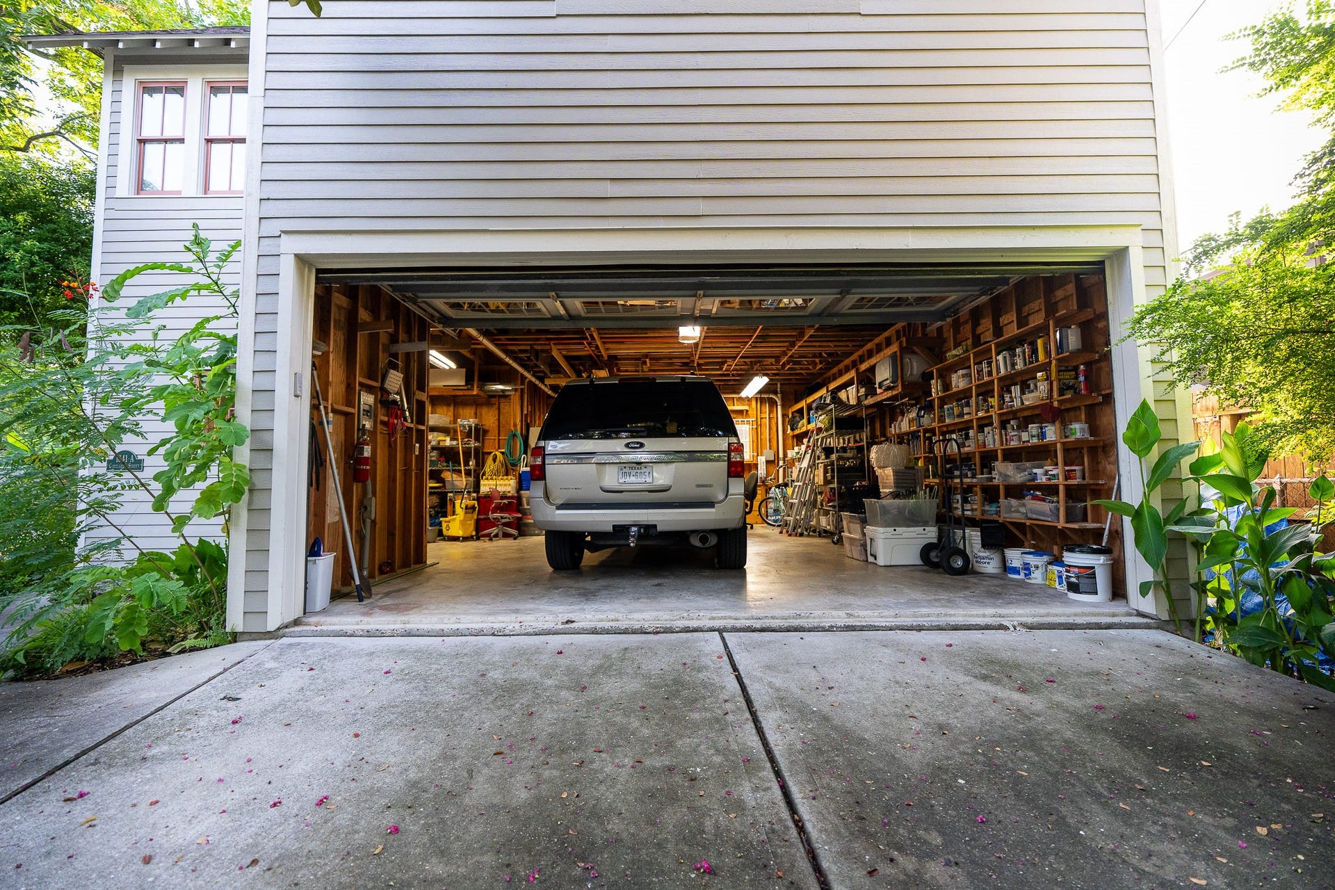 1841 Cortlandt Street, Houston, TX 77008 The garage door is 8' tall, so bring your truck. The garage is aprox 32' X 32' minus the left side minus the cutout sq ft. Big workbench and built in storage. the ceilings are about 10'.