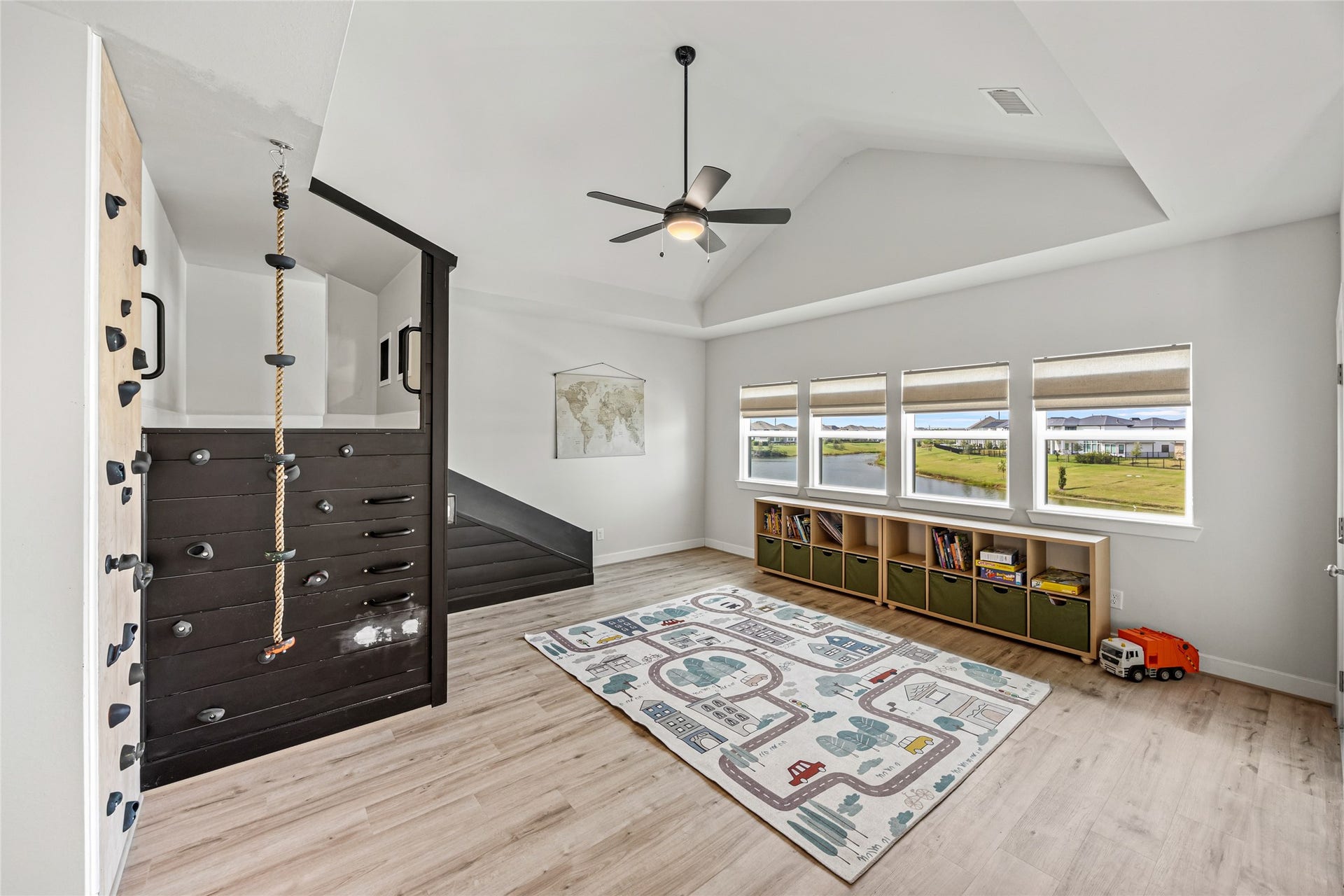 Play area with built-in rock climbing wall and versatile space for childrens activities