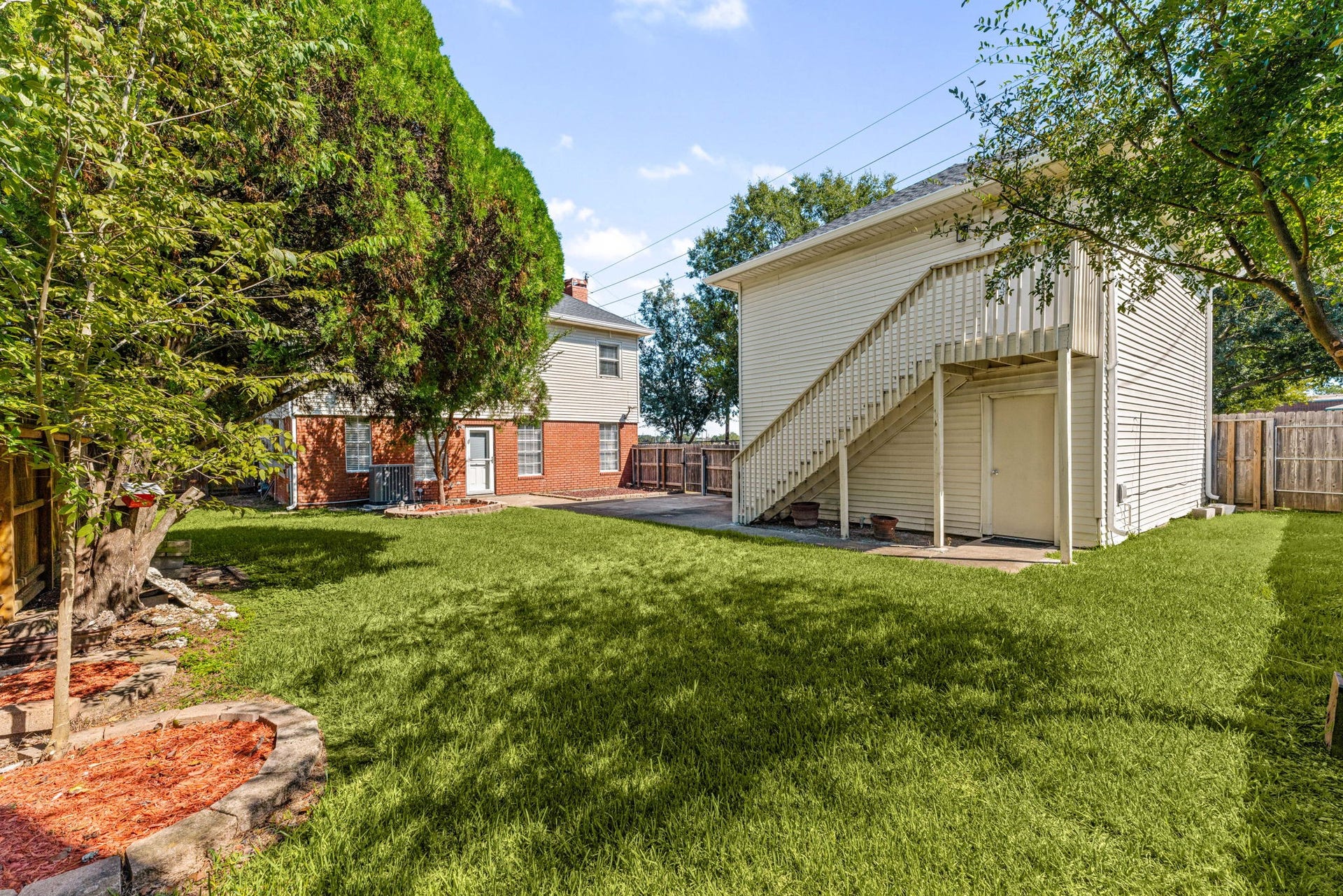 Mature trees, a spacious backyard, and a detached garage with its own apartment make this property stand out from the ordinary.