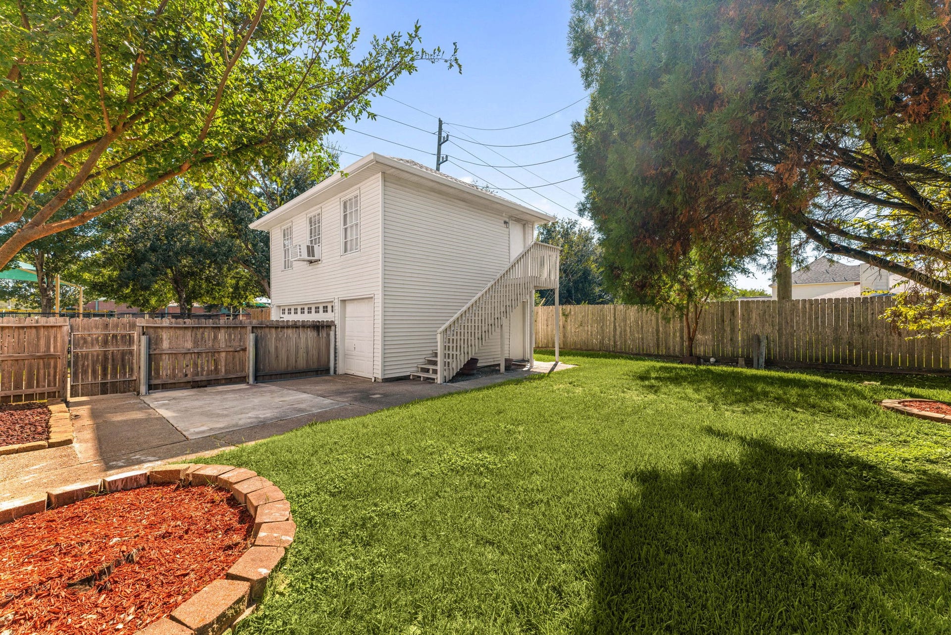 There's more to this property than meets the eye! The detached garage includes a separate apartment above, accessed by its own exterior staircase.