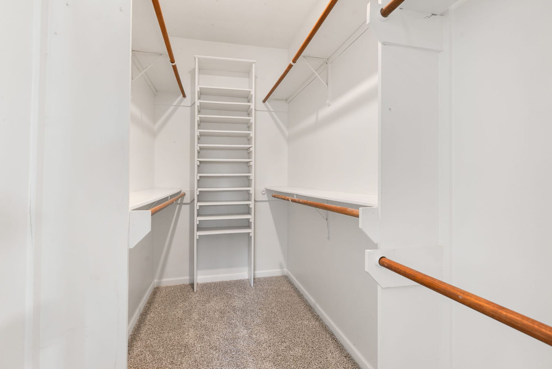 The primary walk-in closet offers plenty of room to get organized, with built-in shelving and generous hanging space.