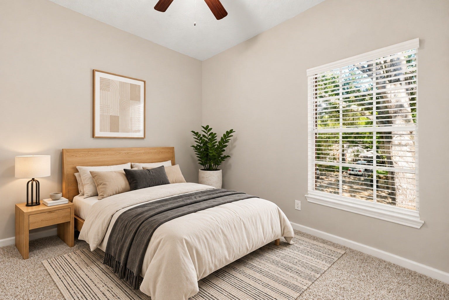 Bright and welcoming, this secondary bedroom offers a comfortable space with fresh carpet, a ceiling fan, and a large window overlooking the front yard. Virtually staged.