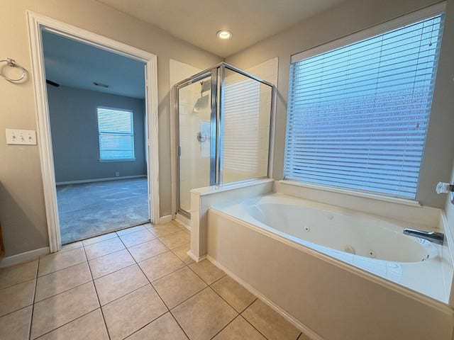 20023 Cypresswood Glen, Spring, TX 77373 Whirlpool soaking tub beneath a large rain glass window offers more natural lighting while giving privacy.