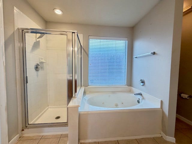 20023 Cypresswood Glen, Spring, TX 77373 Separate tiled shower with rainhead showerhead.