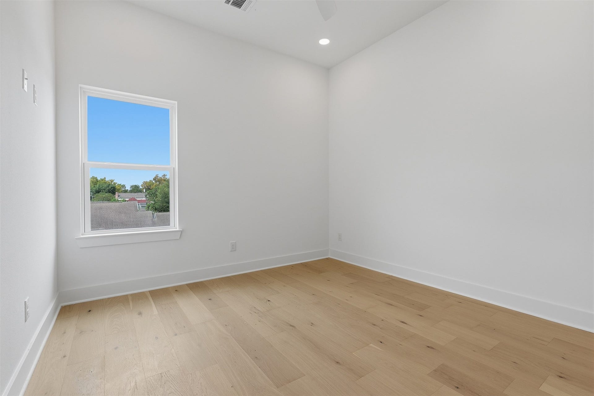 A secondary bedroom adds space for guests or a home office.