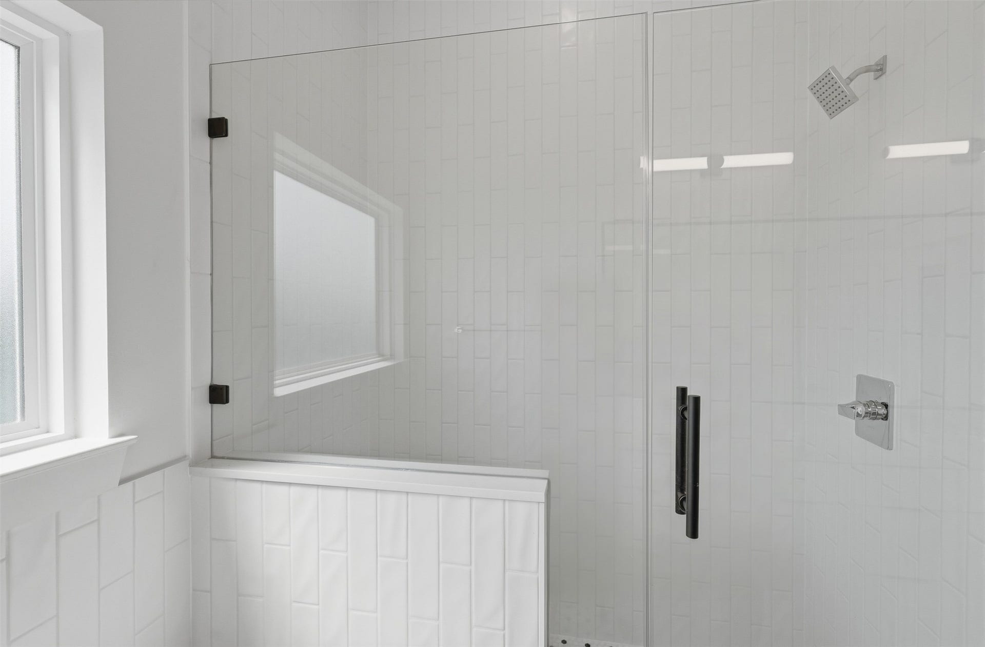 A glass-enclosed shower completes the primary bathroom.