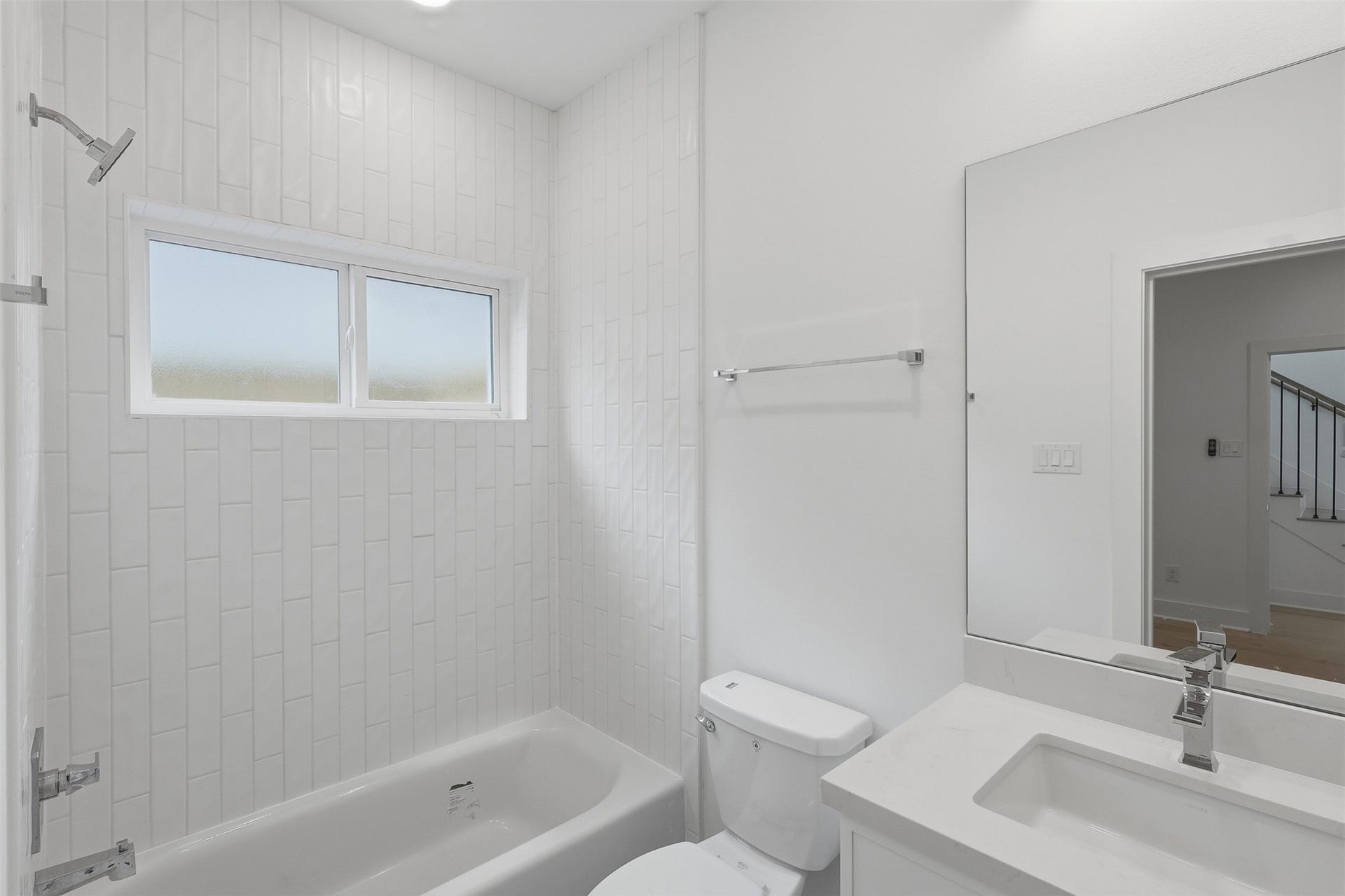 This bathroom also includes a tub and shower combination.