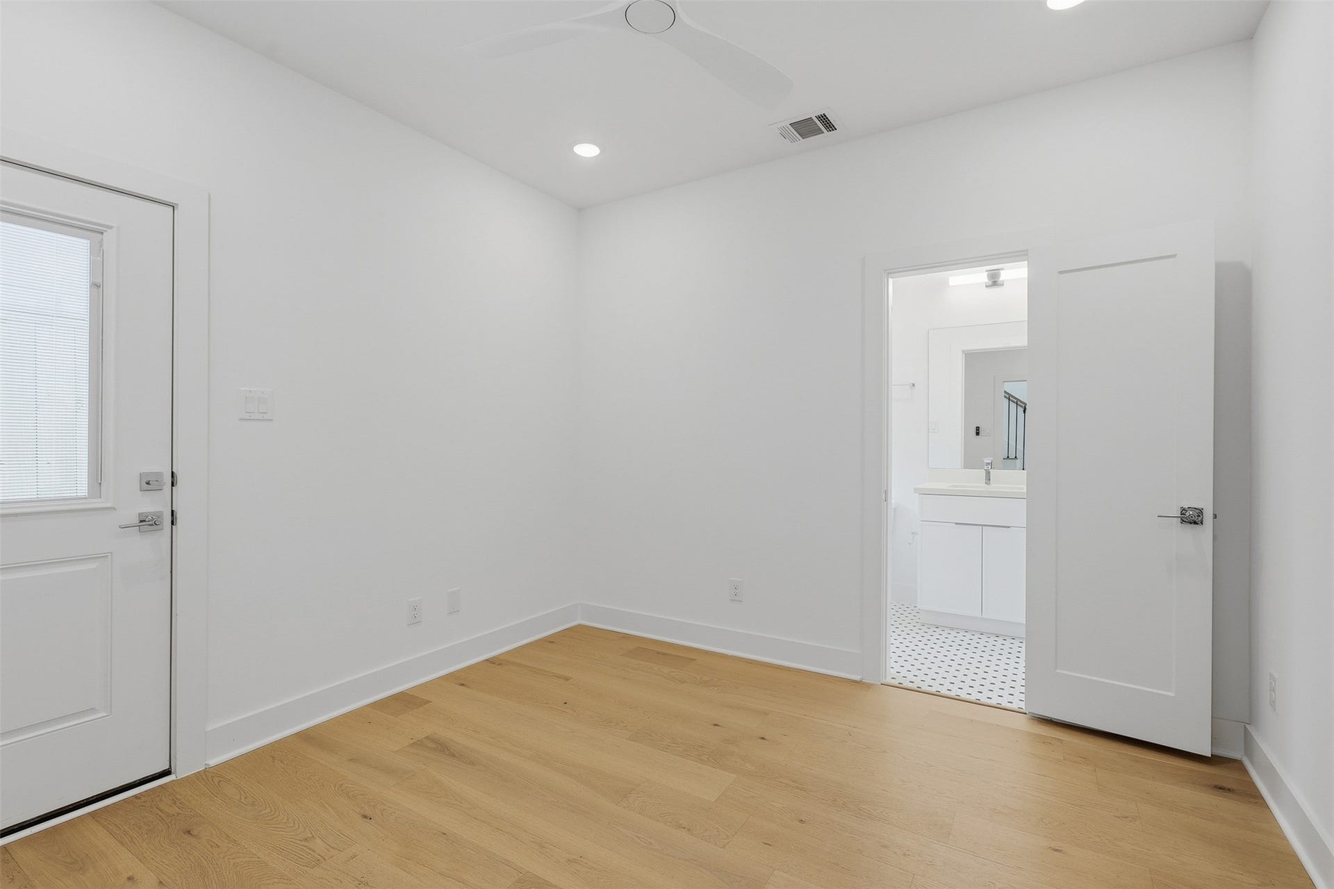 Another bedroom has an adjoining bathroom and an exterior door.