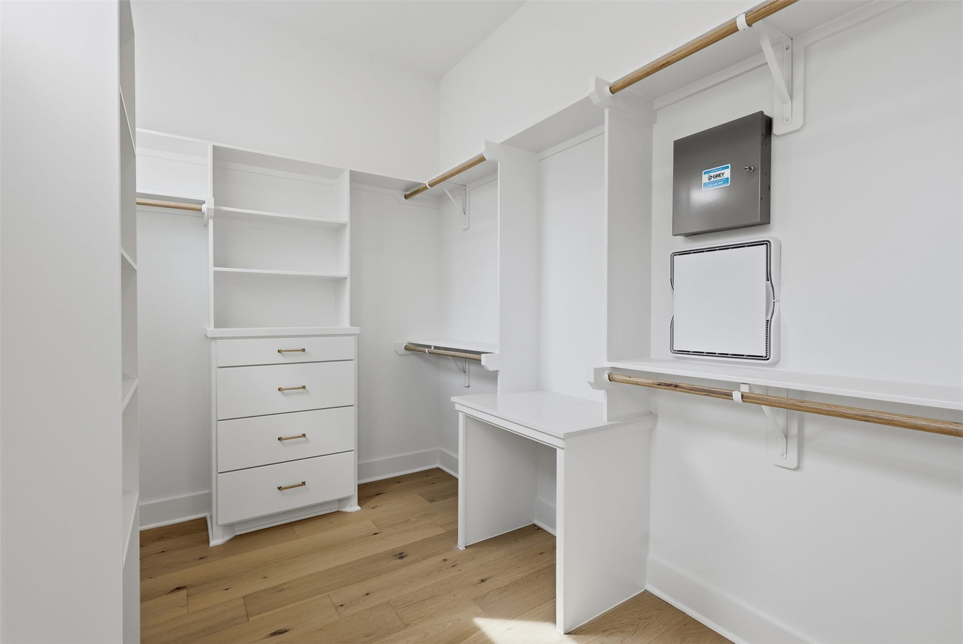The walk-in closet includes drawers, shelves, and hanging space.