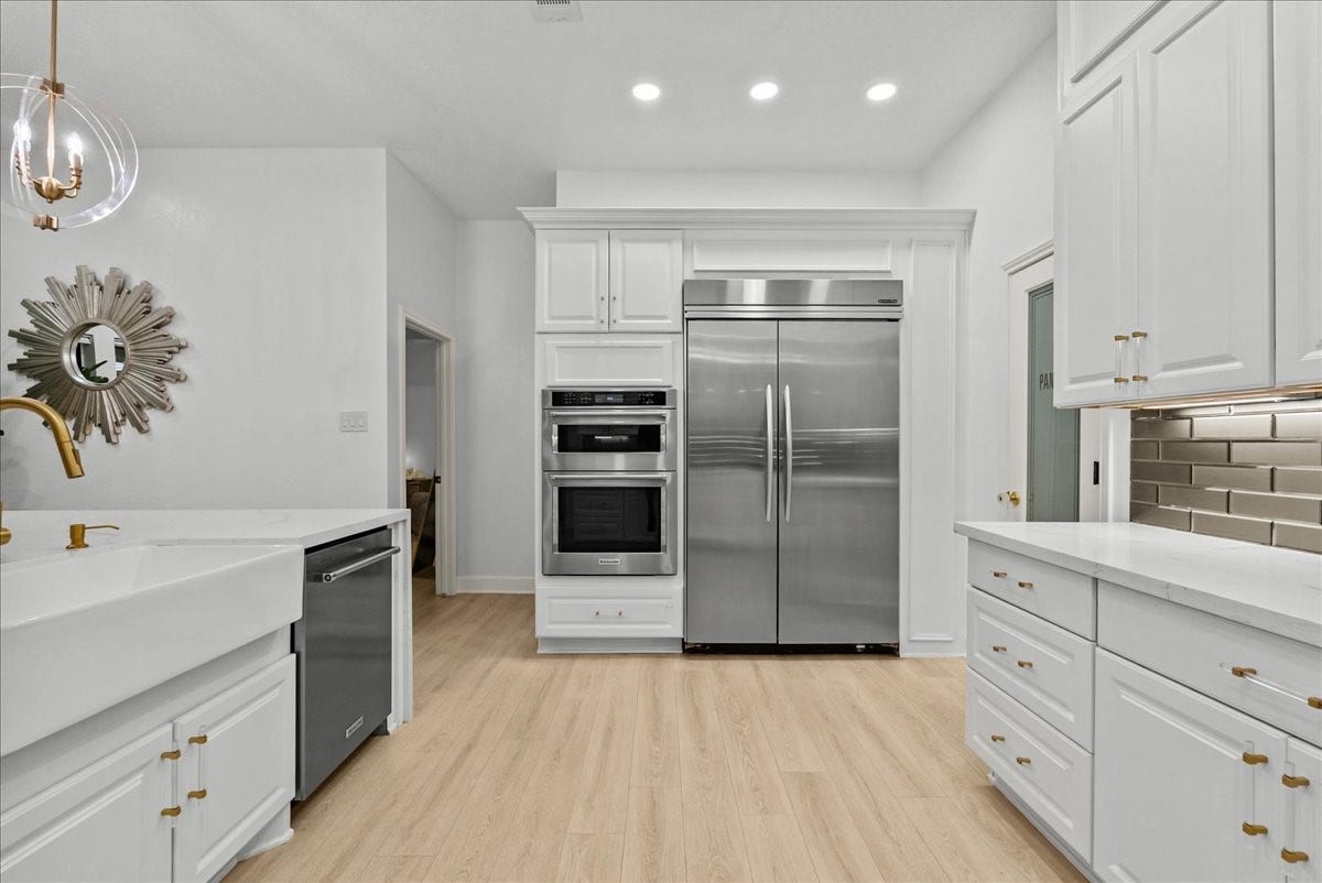 9700 Jay Road, Hitchcock, TX 77563 Thoughtfully designed with custom built-in appliances, a gas cooktop, under-cabinet lighting, and exceptional craftsmanship, this kitchen was created for those who appreciate both beauty and performance.