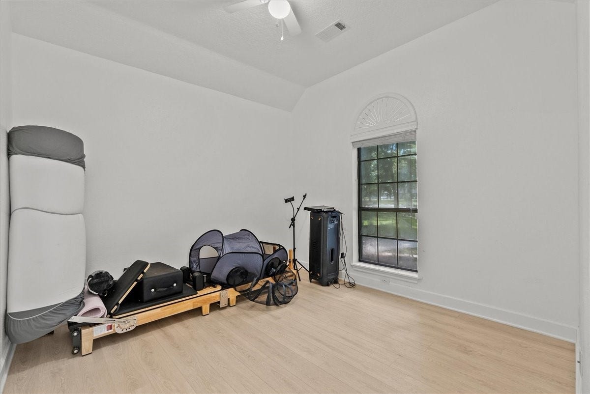 9700 Jay Road, Hitchcock, TX 77563 Currently designed as a private exercise room, this flexible space showcases the possibilities of the home with generous square footage, natural light, and room to create your ideal retreat.