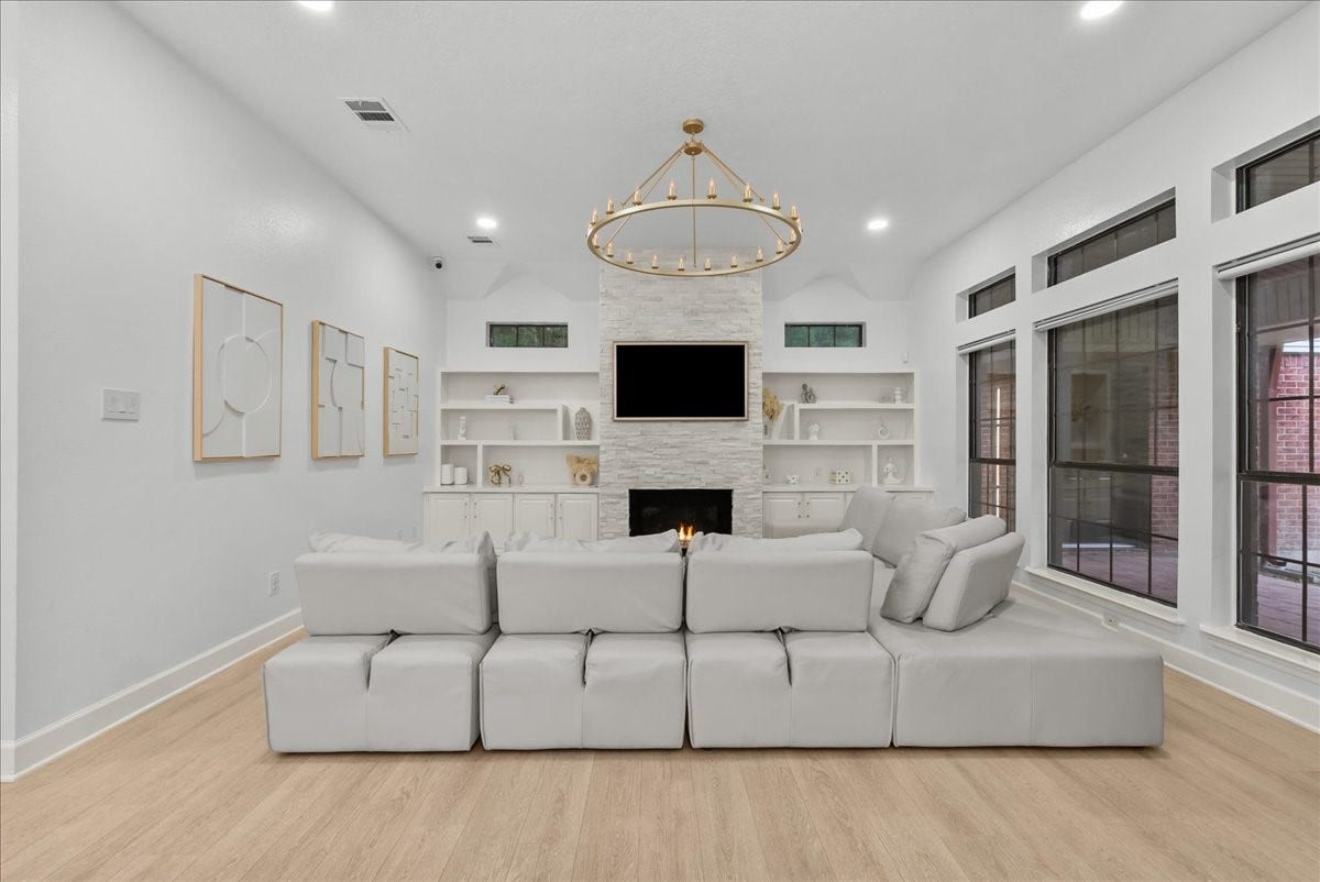 9700 Jay Road, Hitchcock, TX 77563 Soft natural tones, light wood-look flooring, and layered designer finishes come together to create a family room that feels timeless, comfortable, and effortlessly elegant.