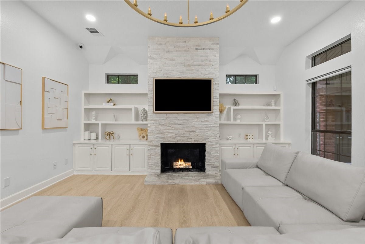 9700 Jay Road, Hitchcock, TX 77563 A beautiful gas fireplace creates an inviting focal point, offering the perfect place to unwind while adding warmth and ambiance throughout the space.