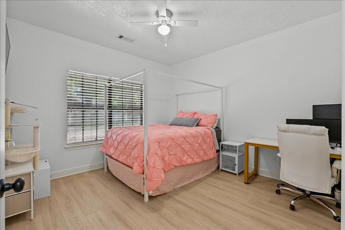 9700 Jay Road, Hitchcock, TX 77563 A beautifully sized secondary bedroom featuring great natural lighting and a versatile layout, perfect for a guest suite, home office, or whatever fits your lifestyle.